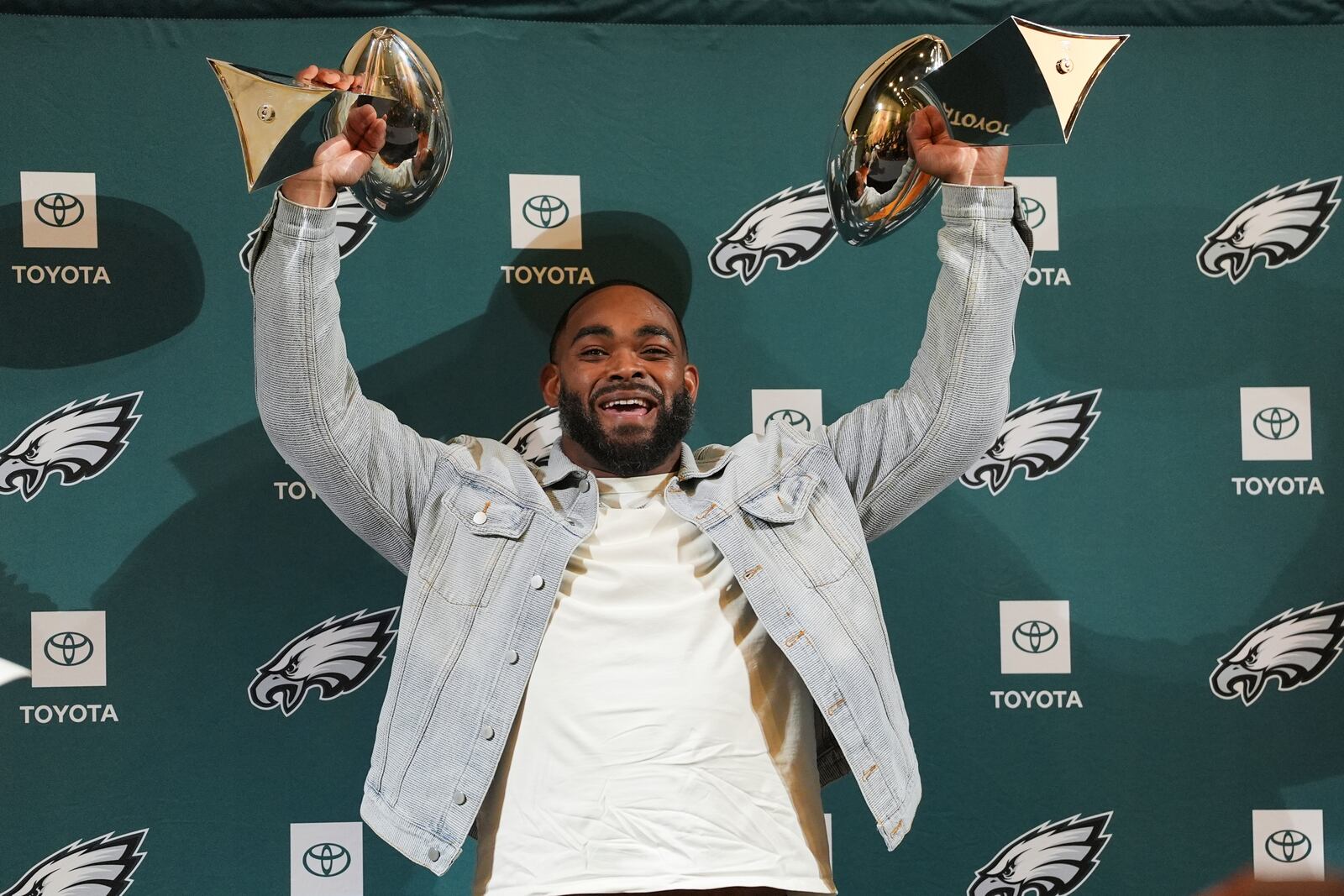 Brandon Graham holds up two Lombardi Trophies during a news conference announcing his retirement, Tuesday, March 18, 2025, at the Philadelphia Eagles' NFL football training facility in Philadelphia. (AP Photo/Matt Rourke