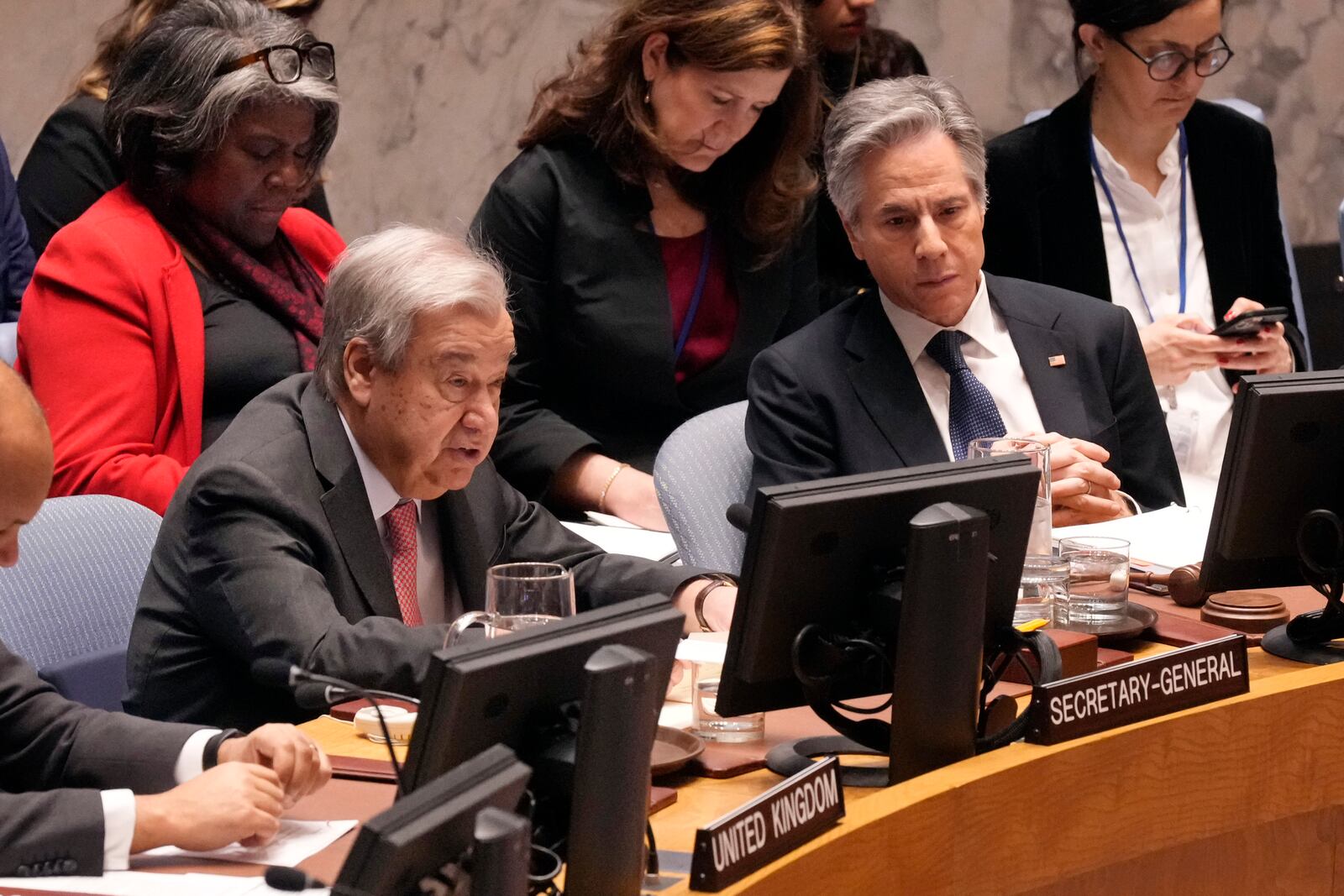 U.S. Secretary of State Antony Blinken, right, listens as UN Secretary General Antonio Guterres, left, delivers his remarks in the United Nations Security Council, Thursday, Dec. 19, 2024. US Ambassador Linda Thomas-Greenfield is seated, upper left. (AP Photo/Richard Drew)