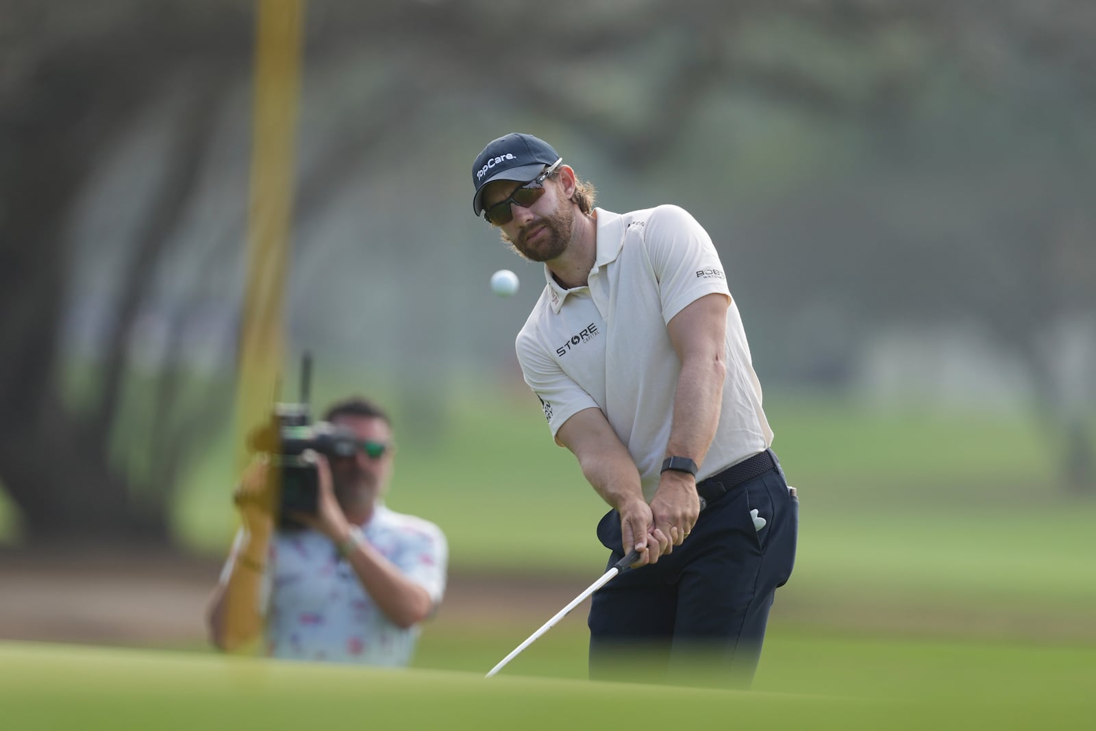 Patrick Rodgers, of the United States, chips onto the green of the 15th hole during the second round of the Mexico Open golf tournament in Puerto Vallarta, Mexico, Friday, Feb. 21, 2025. (AP Photo/Fernando Llano)