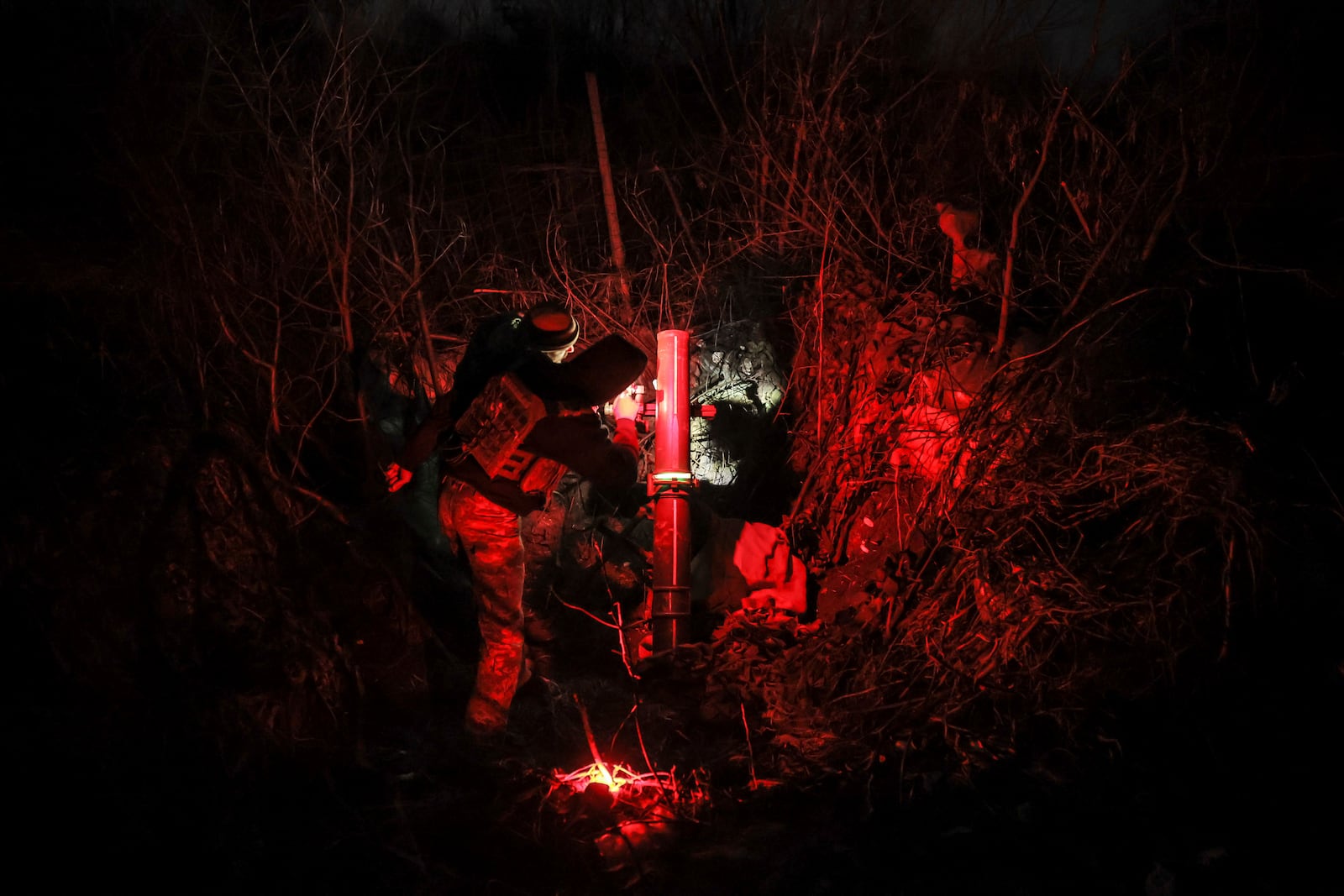 In this photo provided by Ukraine's 24th Mechanised Brigade press service, serviceman of the 24th Mechanised Brigade prepares to fire 120mm mortar towards Russian positions near Chasiv Yar town, in Donetsk region, Ukraine, Tuesday, Nov. 19, 2024. (Oleg Petrasiuk/Ukrainian 24th Mechanised Brigade via AP)