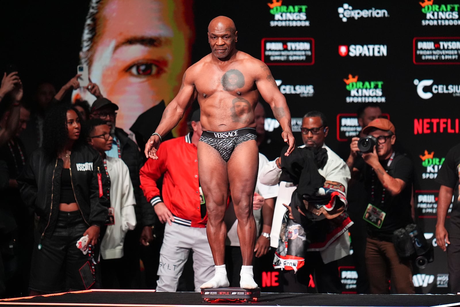 Mike Tyson steps on the scale during a weigh-in ahead of his heavyweight bout against Jake Paul, Thursday, Nov. 14, 2024, in Irving, Texas. (AP Photo/Julio Cortez)