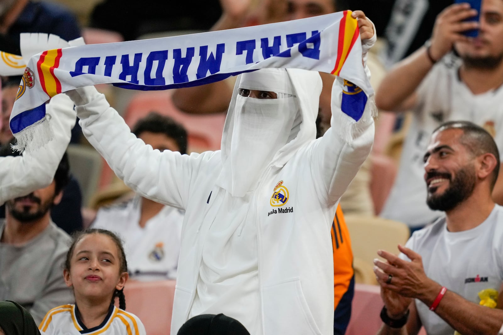 Supporter cheer before the Spanish Super Cup semifinal soccer match between Real Madrid and Mallorca at the King Abdullah Stadium in Jeddah, Saudi Arabia, Thursday, Jan. 9, 2025. (AP Photo/Altaf Qadri)