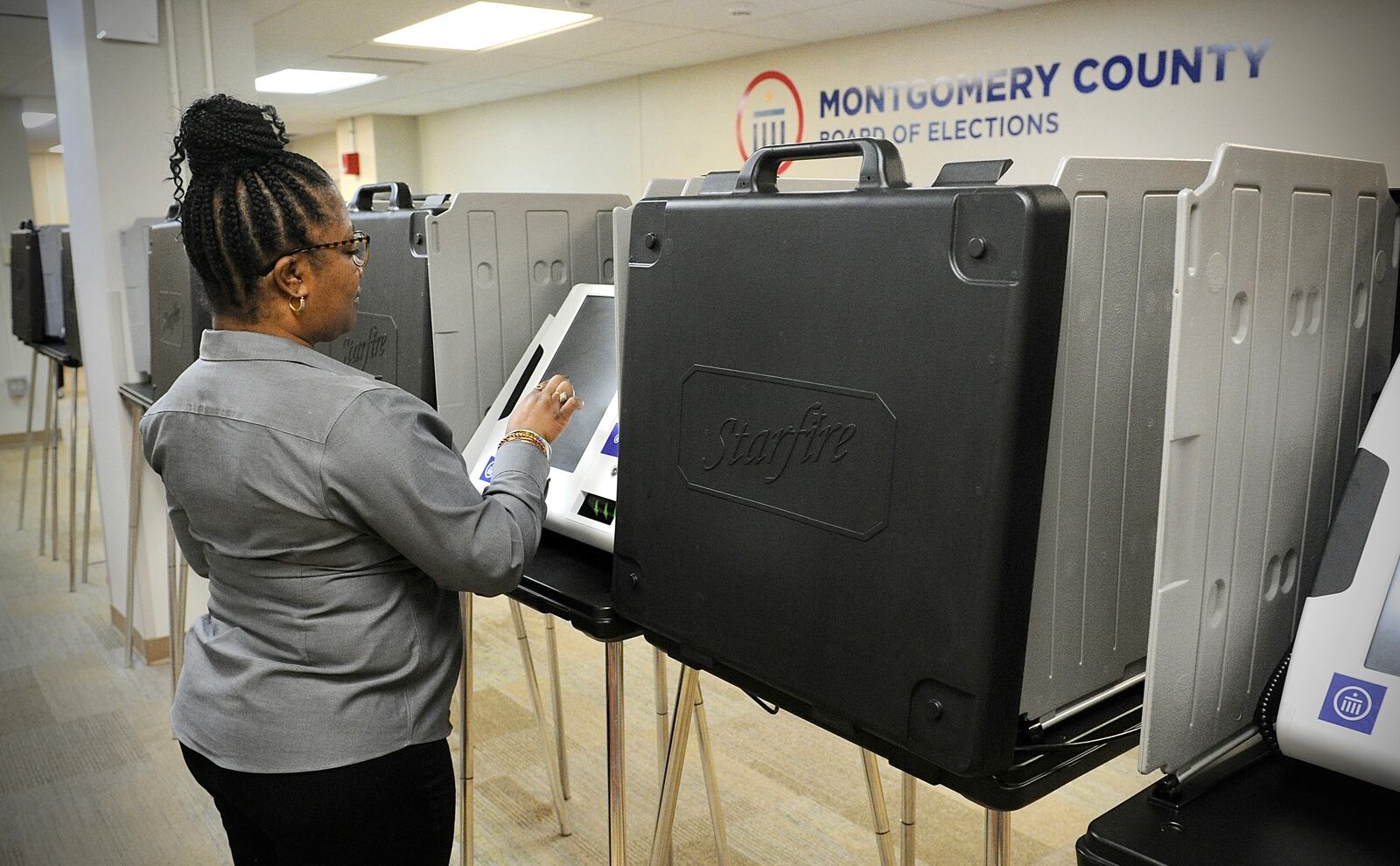 Inger Marsh looks over one of the polling machines at the Montgomery County Board of Elections Wednesday March 24, 2022. MARSHALL GORBY\STAFF