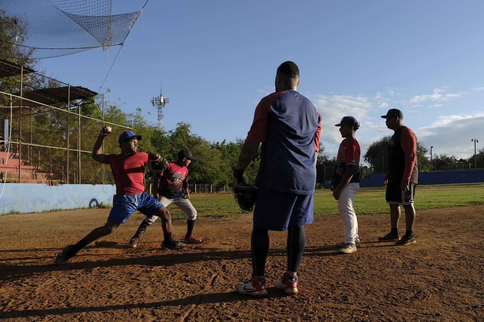 Teenage baseball players practice during their daily training at the Trinitarios ballpark in Santo Domingo, Dominican Republic, Wednesday, Feb. 5, 2025. (AP Photo/Ricardo Hernandez)