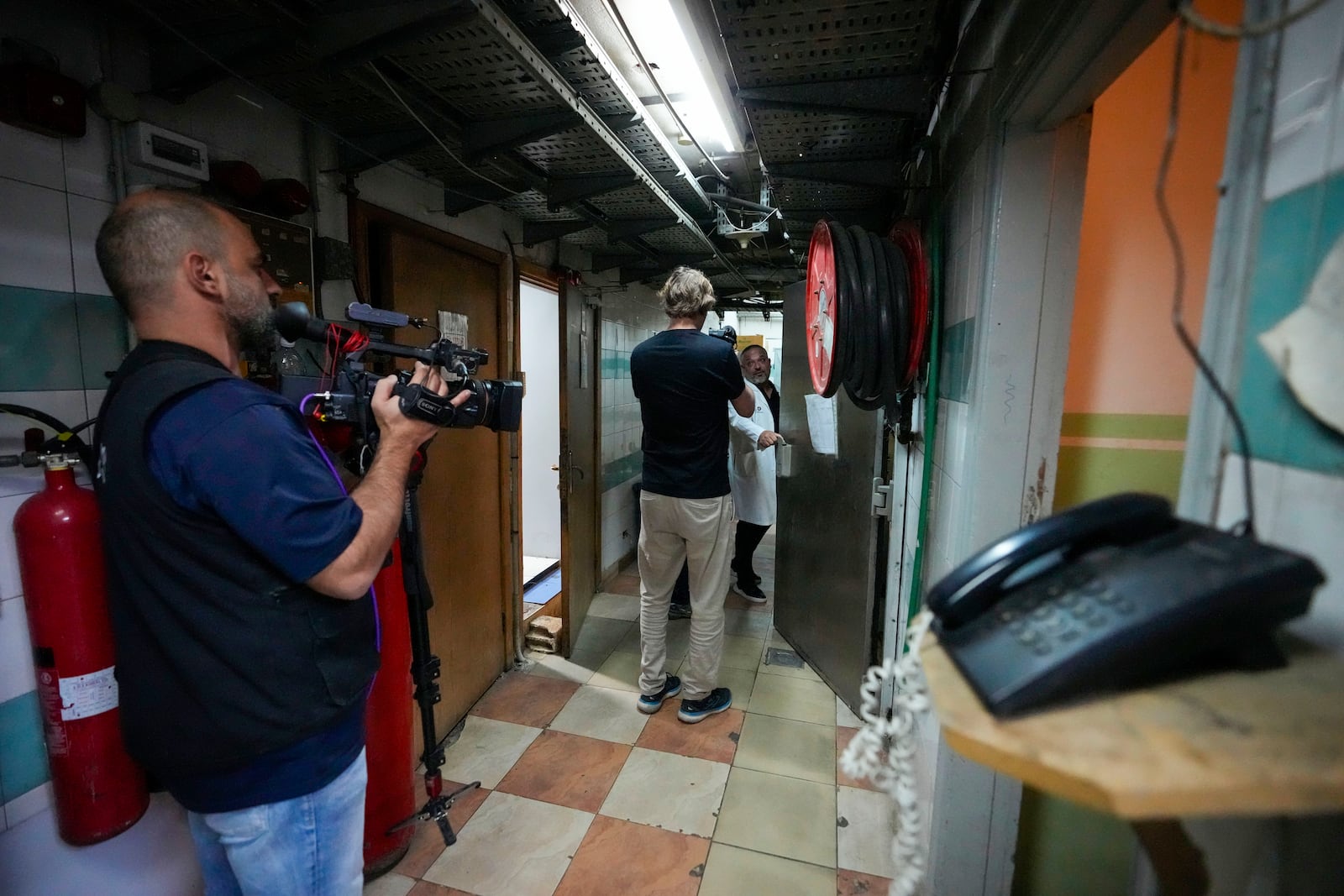 Foreign and local journalists take a tour inside Sahel General Hospital, in Dahiyeh, Beirut, Lebanon, Tuesday, Oct. 22, 2024, a day after the Israeli army said that Hezbollah is storing hundreds of millions of dollars in cash and gold under the hospital. (AP Photo/Hassan Ammar)