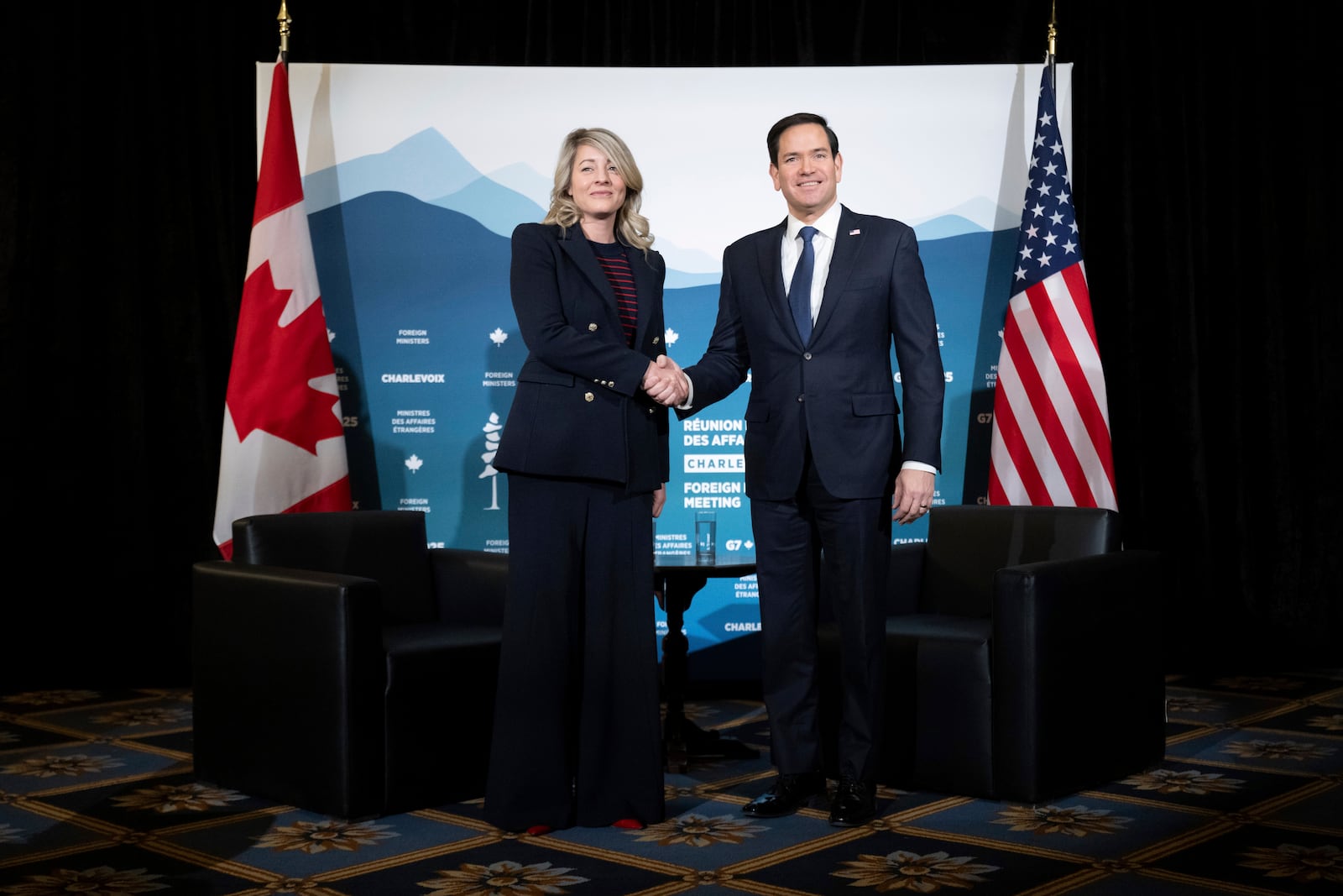 Canadian Foreign Minister Melanie Joly, left, and US Secretary of State Marco Rubio pose for photos on the sidelines of the G7 foreign ministers meeting in La Malbaie, Canada, Friday March 14, 2025. (Saul Loeb, Pool Photo via AP)