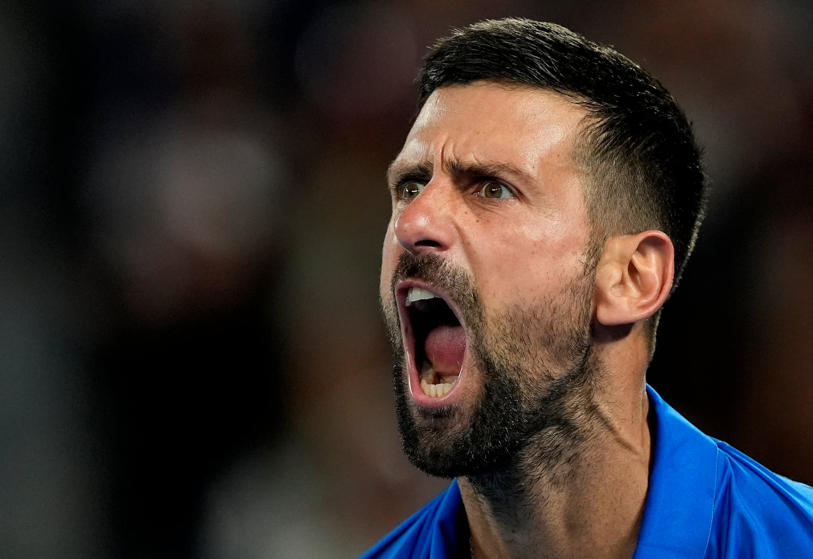 Novak Djokovic of Serbia reacts after winning a point against Tomas Machac of the Czech Republic during their third round match at the Australian Open tennis championship in Melbourne, Australia, Friday, Jan. 17, 2025. (AP Photo/Asanka Brendon Ratnayake)