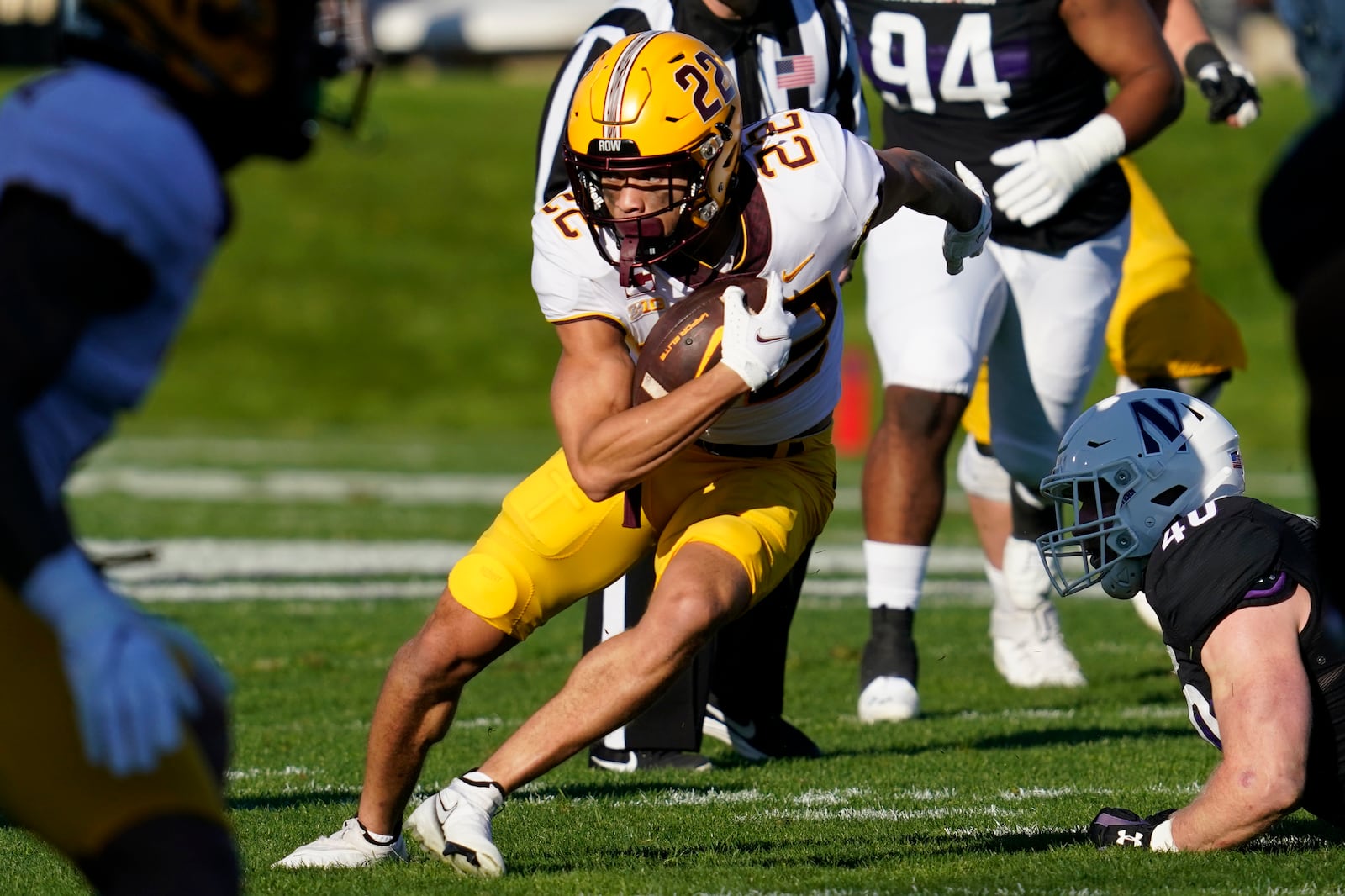 Minnesota wide receiver Mike Brown-Stephens (22) runs with the ball past Northwestern linebacker Peter McIntyre (40) during the first half of an NCAA college football game in Evanston, Ill., Saturday, Oct. 30, 2021. (AP Photo/Nam Y. Huh)