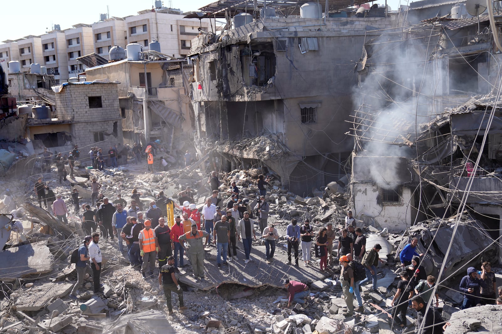 Rescue workers search for victims at popular neighbourhood that was hit Monday night by Israeli airstrikes, south of Beirut, Lebanon, Tuesday, Oct. 22, 2024. (AP Photo/Hussein Malla)