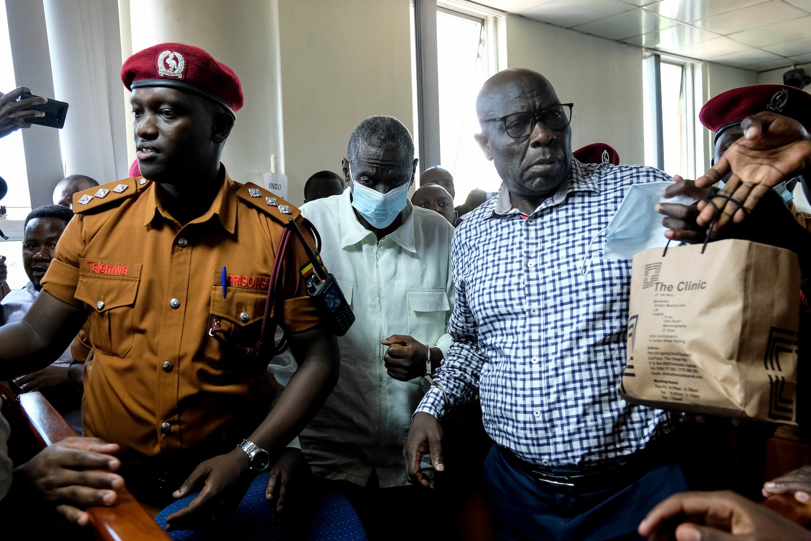 Ugandan opposition leader and four-time presidential candidate Kizza Besigye, second left centre, arrives in a civilian court in Kampala, Uganda Wednesday, Feb. 19, 2025. (AP Photo/Hajarah Nalwadda)