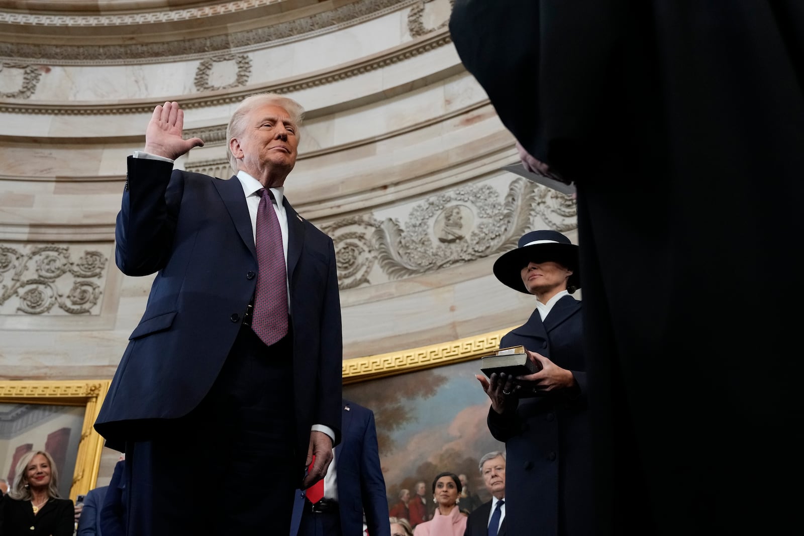 Donald Trump is sworn in as the 47th president of the United States by Chief Justice John Roberts as Melania Trump holds the Bible during the 60th Presidential Inauguration in the Rotunda of the U.S. Capitol in Washington, Monday, Jan. 20, 2025. (AP Photo/Morry Gash, Pool)