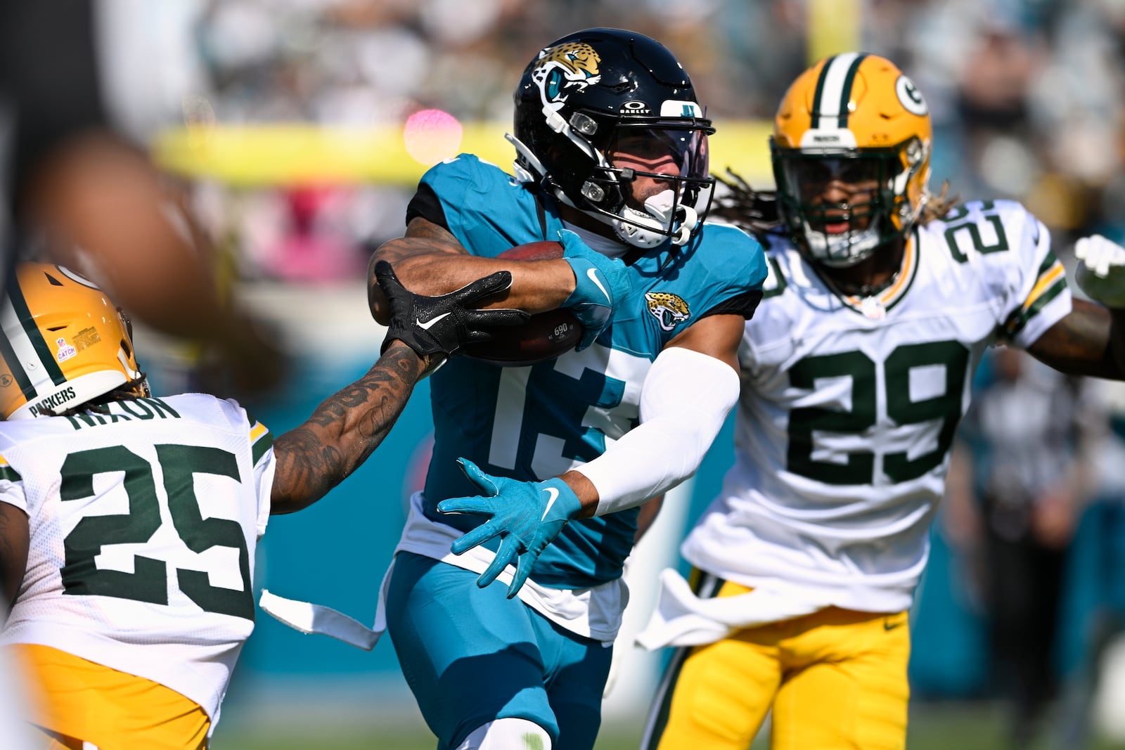 Jacksonville Jaguars' Christian Kirk runs past Green Bay Packers' Keisean Nixon (25) after a catch during the first half of an NFL football game Sunday, Oct. 27, 2024, in Jacksonville, Fla. (AP Photo/Phelan M. Ebenhack)