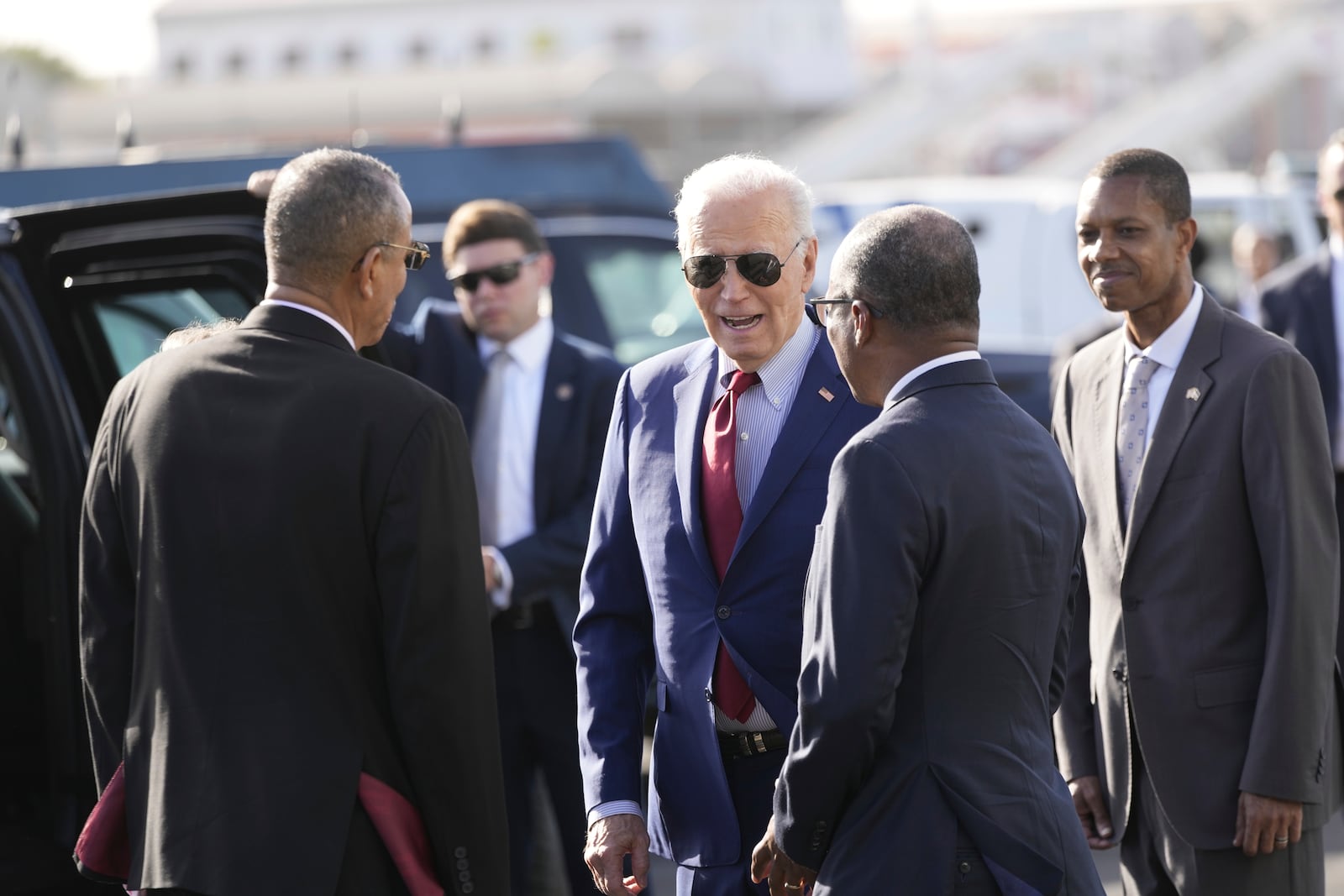 President Joe Biden speaks with Cape Verde's Prime Minister Ulisses Correia e Silva , right, and Jose Luis Livramento, Cabo Verde Ambassador to the U.S at Amilcar Cabral international airport on Sal island, Cape Verde Monday, Dec. 2, 2024, en route to Angola as he makes his long-promised visit to Africa. (AP Photo/Ben Curtis)