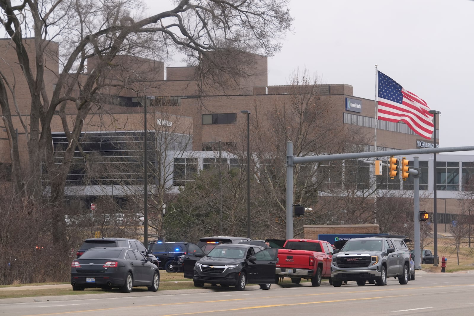 Law enforcement arrive at Corewell Health Beaumont Troy Hospital in Troy, Mich., Thursday, March 20, 2025. (AP Photo/Paul Sancya)