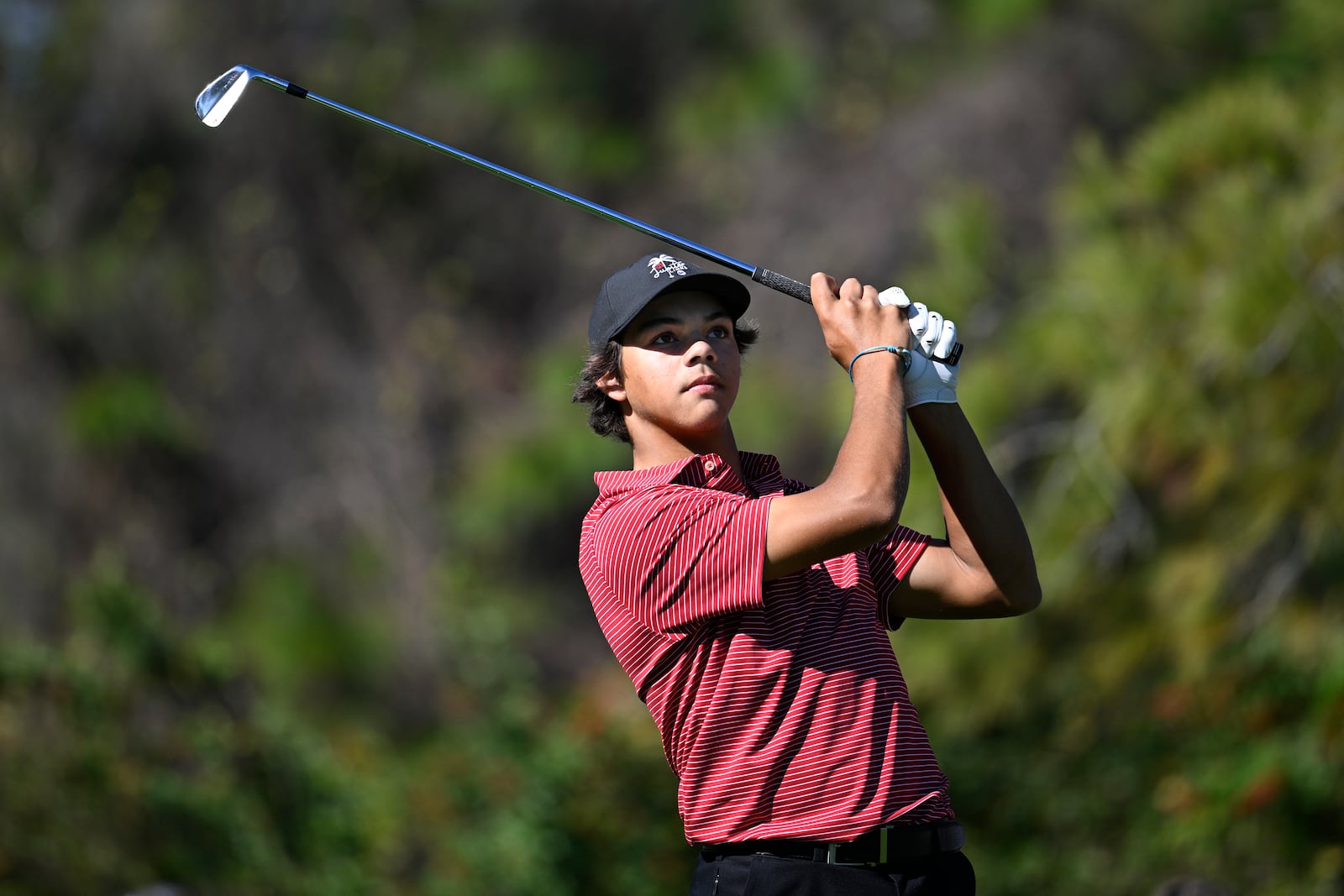 Charlie Woods watches his tee shot on the fourth hole that went in for a hole-in-one during the final round of the PNC Championship golf tournament, Sunday, Dec. 22, 2024, in Orlando, Fla. (AP Photo/Phelan M. Ebenhack)