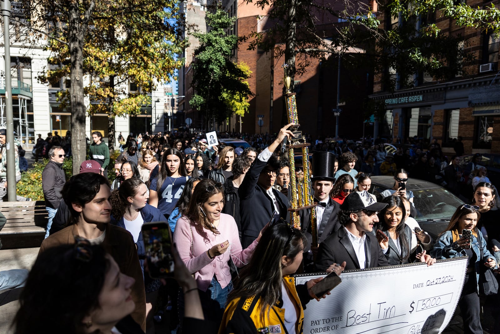 The trophy for the Timothee Chalamet lookalike contest is paraded through the street as the contest organizers move the event to a new location near Washington Square Park, Sunday, Oct. 27, 2024, in New York. (AP Photo/Stefan Jeremiah)