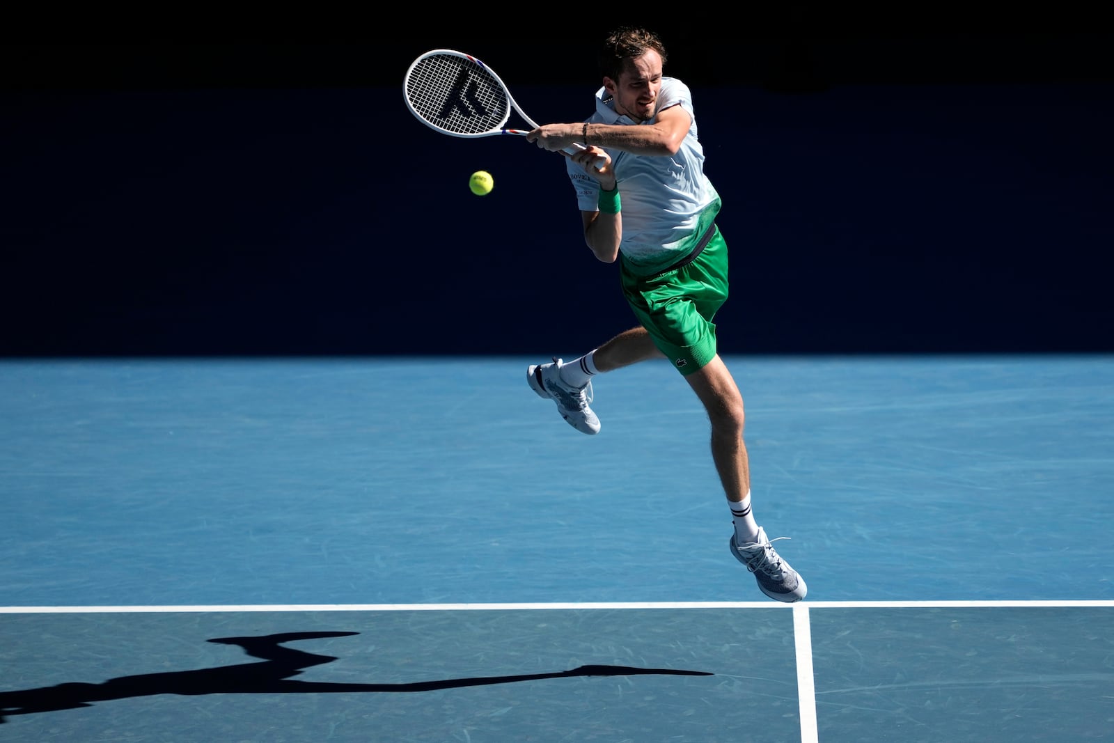 Daniil Medvedev of Russia plays a backhand return to Kasidit Samrej of Thailand during their first round match at the Australian Open tennis championship in Melbourne, Australia, Tuesday, Jan. 14, 2025. (AP Photo/Ng Han Guan)