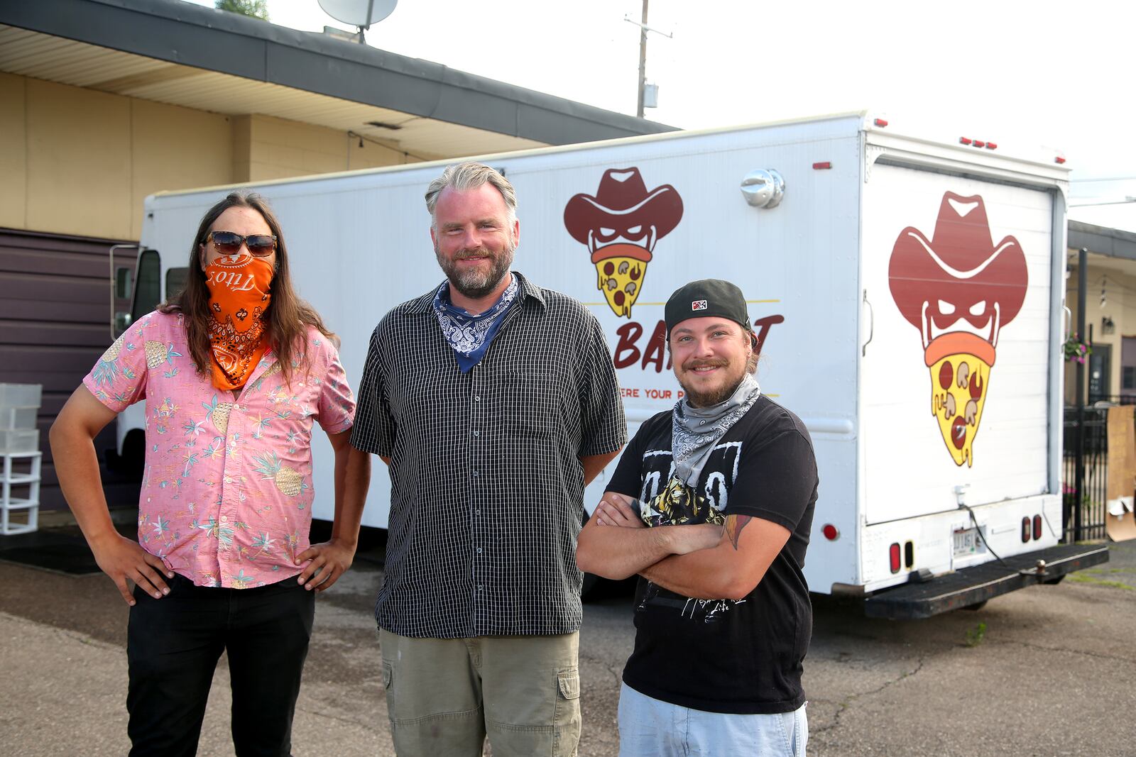 Brian Johnson, Mark Jeffers and James Burton (left to right) are the owners of the Pizza Bandit, a New York style pizza truck that can found at the Yellow Cab Tavern in Dayton.  LISA POWELL / STAFF