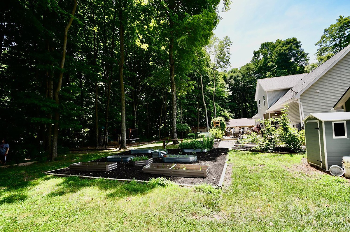 The rear of the home is also heavily wooded, has raised garden beds, 2 sheds, an above-ground pool with deck and oversized concrete patio. There is also a professionally designed play area. CONTRIBUTED PHOTO