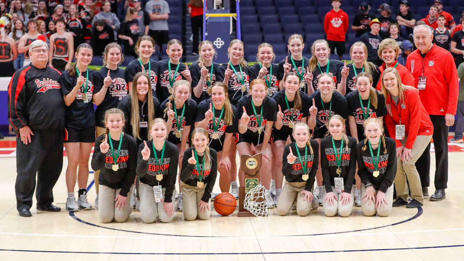 The Fort Loramie High School girls basketball program poses with the trophy after beating Waterford 42-29 to win the 2024 Division IV state championship game on Saturday, March 16 at University of Dayton Arena. Michael Cooper/CONTRIBUTED