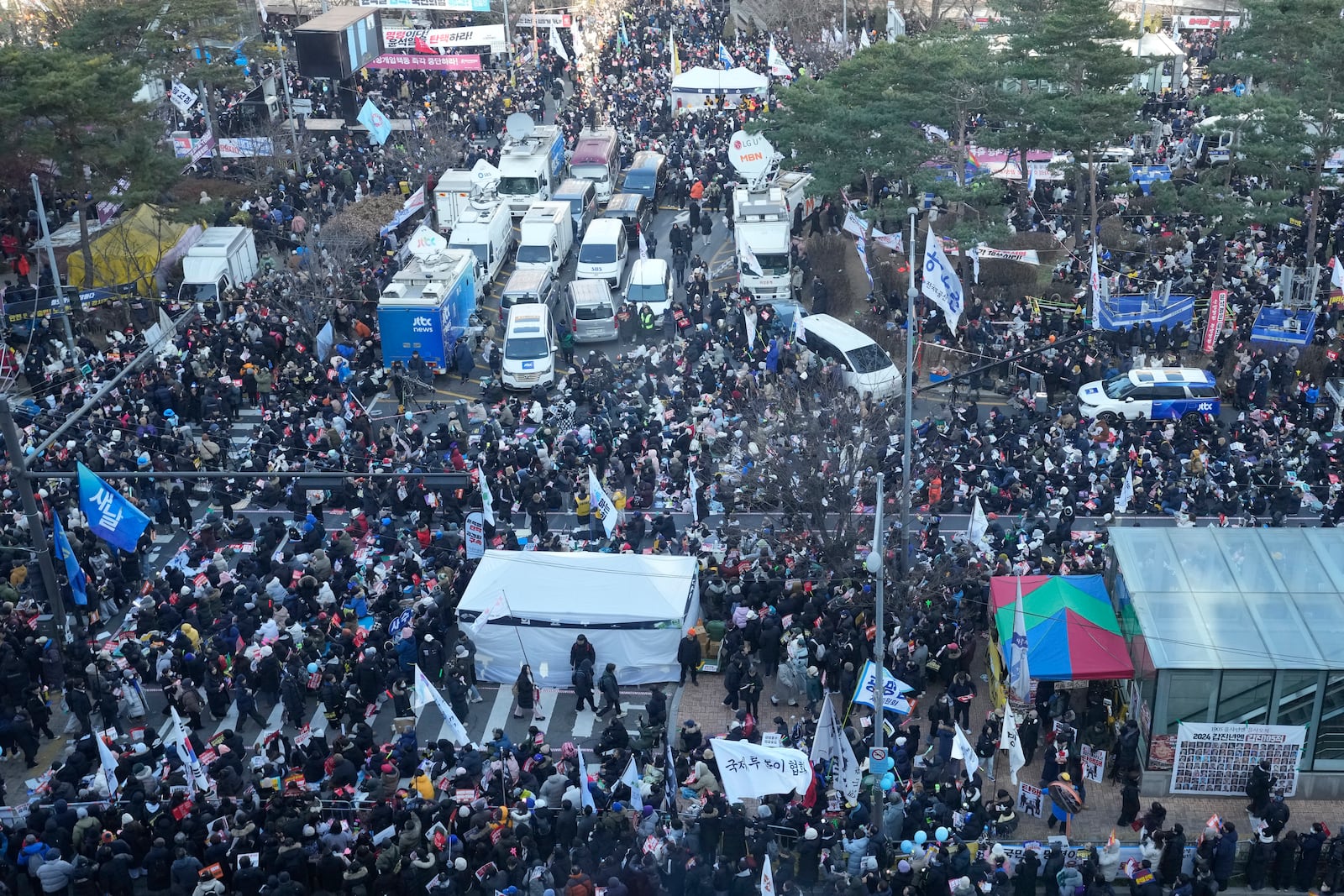 Participants gather during a rally to demand South Korean President Yoon Suk Yeol's impeachment outside the National Assembly in Seoul, South Korea, Saturday, Dec. 14, 2024. (AP Photo/Ahn Young-joon)