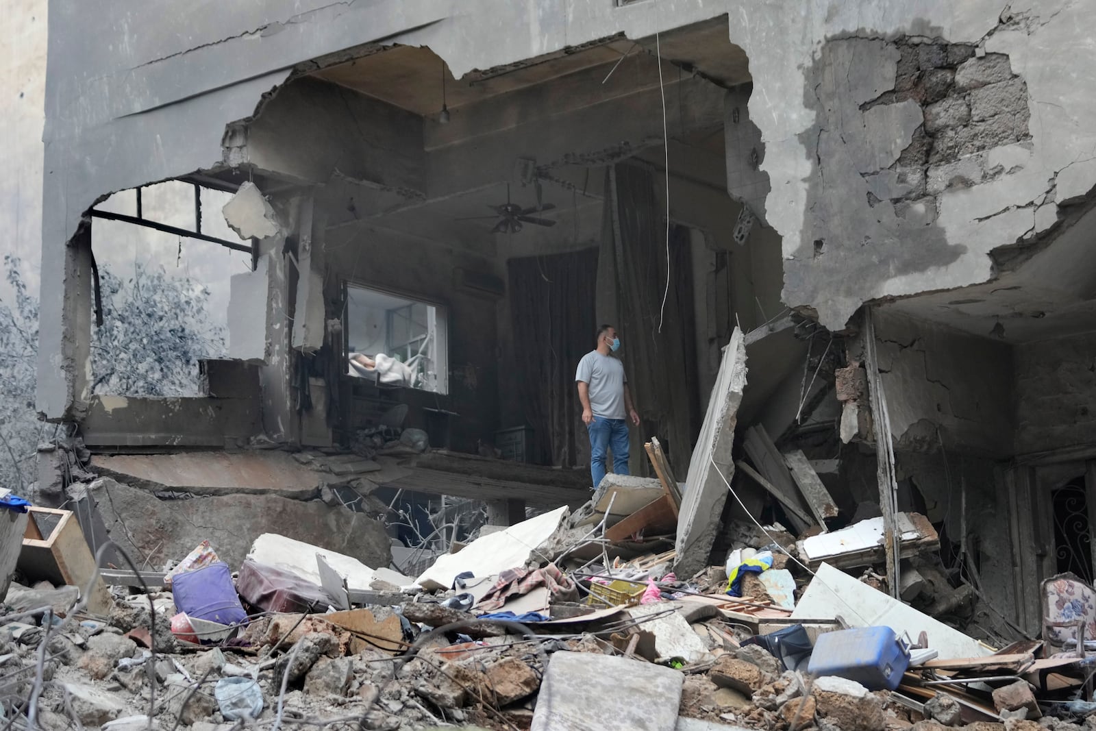 A man checks his destroyed house at the site of Thursday's Israeli airstrike, in Beirut, Lebanon, Friday, Oct. 11, 2024. (AP Photo/Hussein Malla)