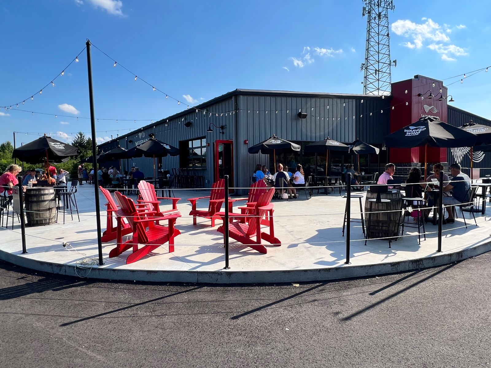 Diners on the patio at Warped Wing Brewery & Smokery in Huber Heights can hear music from the nearby Rose Music Center on concert nights.  ALEXIS LARSEN/CONTRIBUTOR