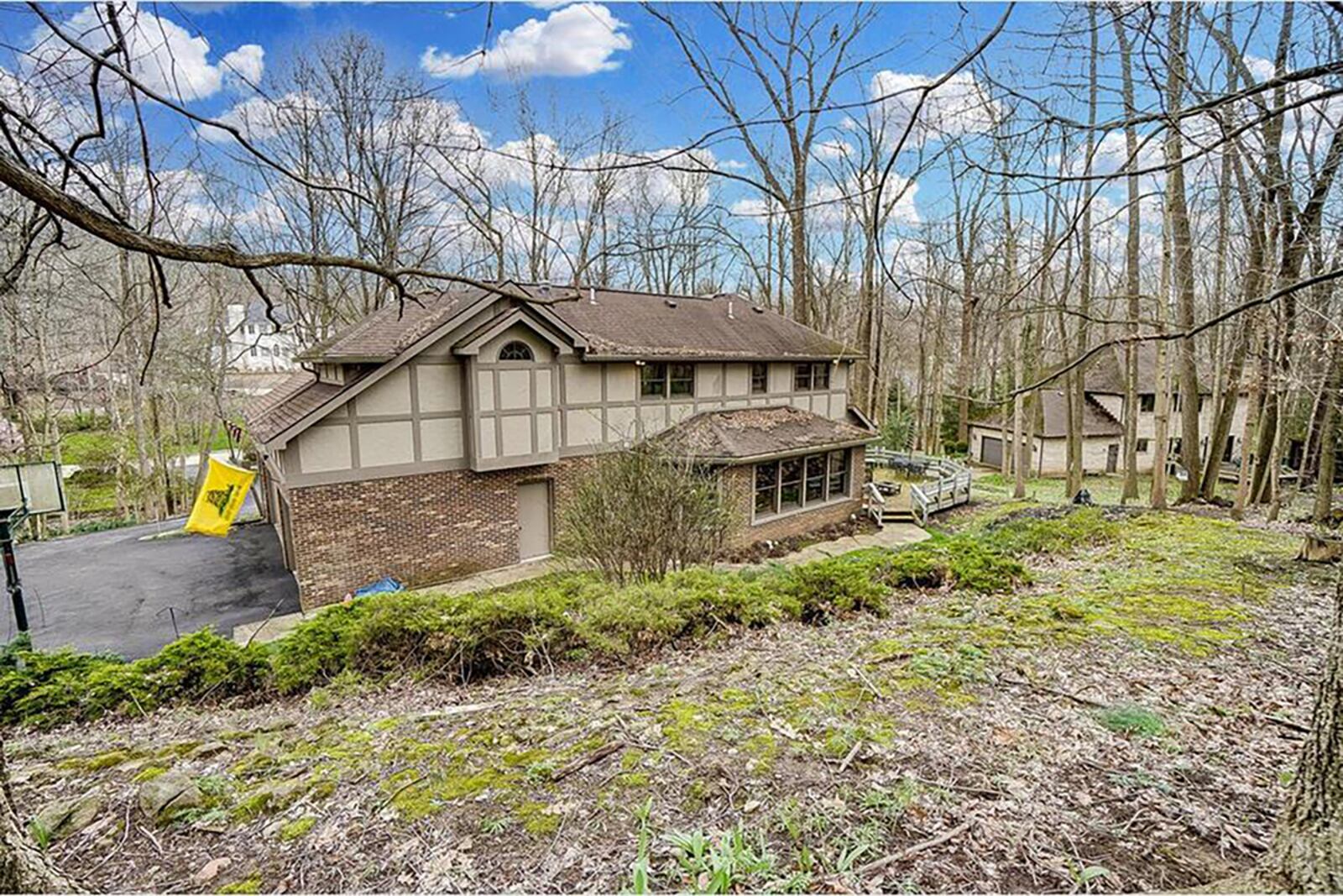 The rear of the property is also wooded and features a circular wood deck with railings and is heavily landscaped. CONTRIBUTED PHOTO