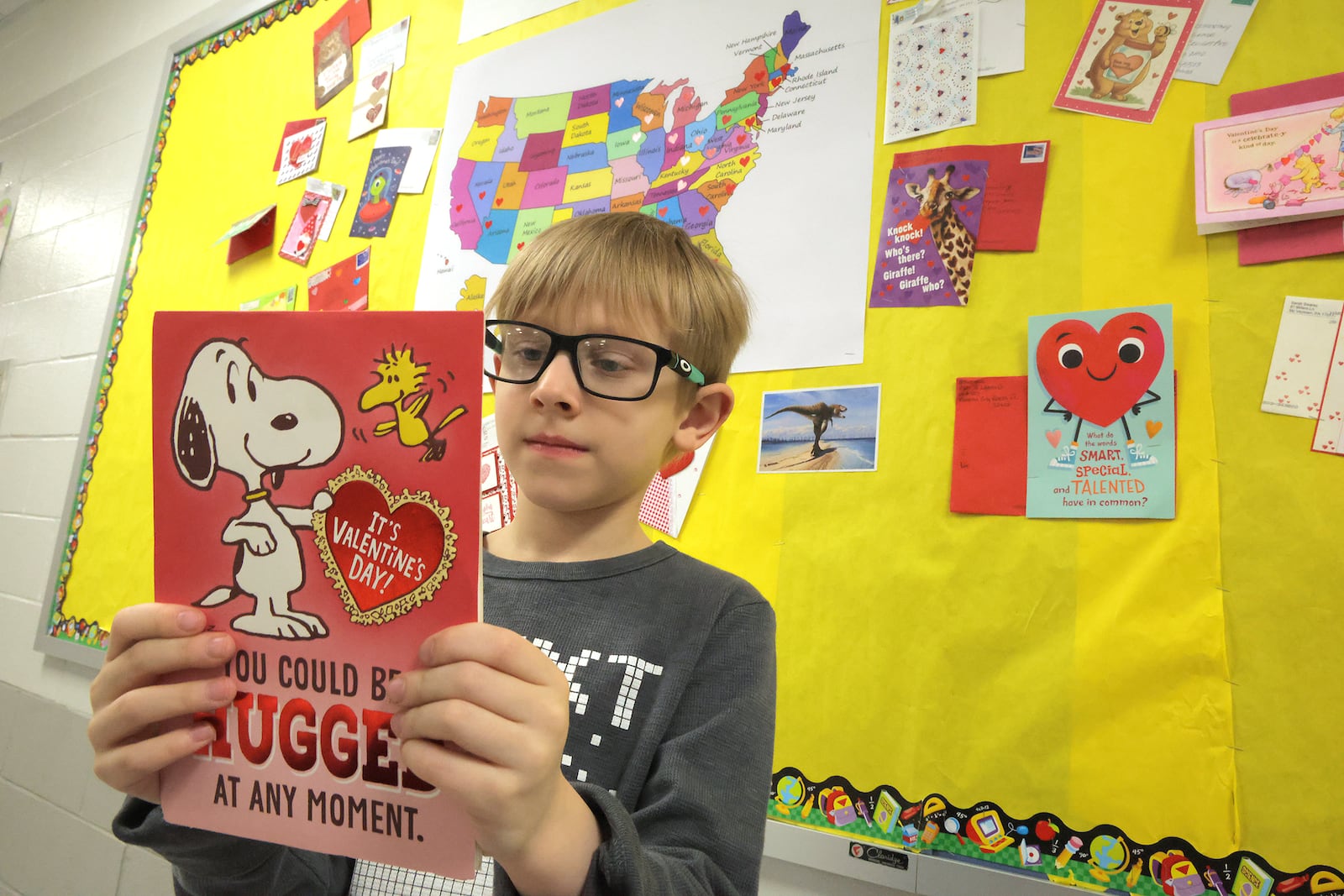 Milo Wiedeke, a second grader at Lagonda Elementary School, looks over one of the Valentines Day cards his class received from all over the country Tuesday, Feb. 11, 2025. BILL LACKEY/STAFF