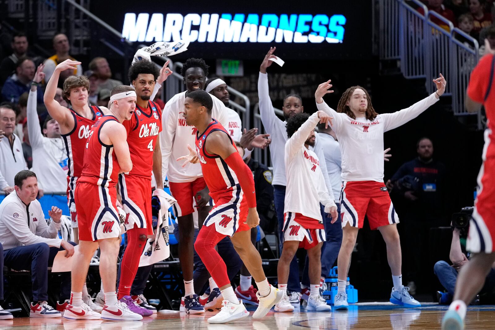 Mississippi guard Matthew Murrell, front center, reacts to scoring a 3-point basket with guard Sean Pedulla, second from left, and the team bench during the second half in the second round of the NCAA college basketball tournament against Iowa State, Sunday, March 23, 2025, in Milwaukee. (AP Photo/Kayla Wolf)