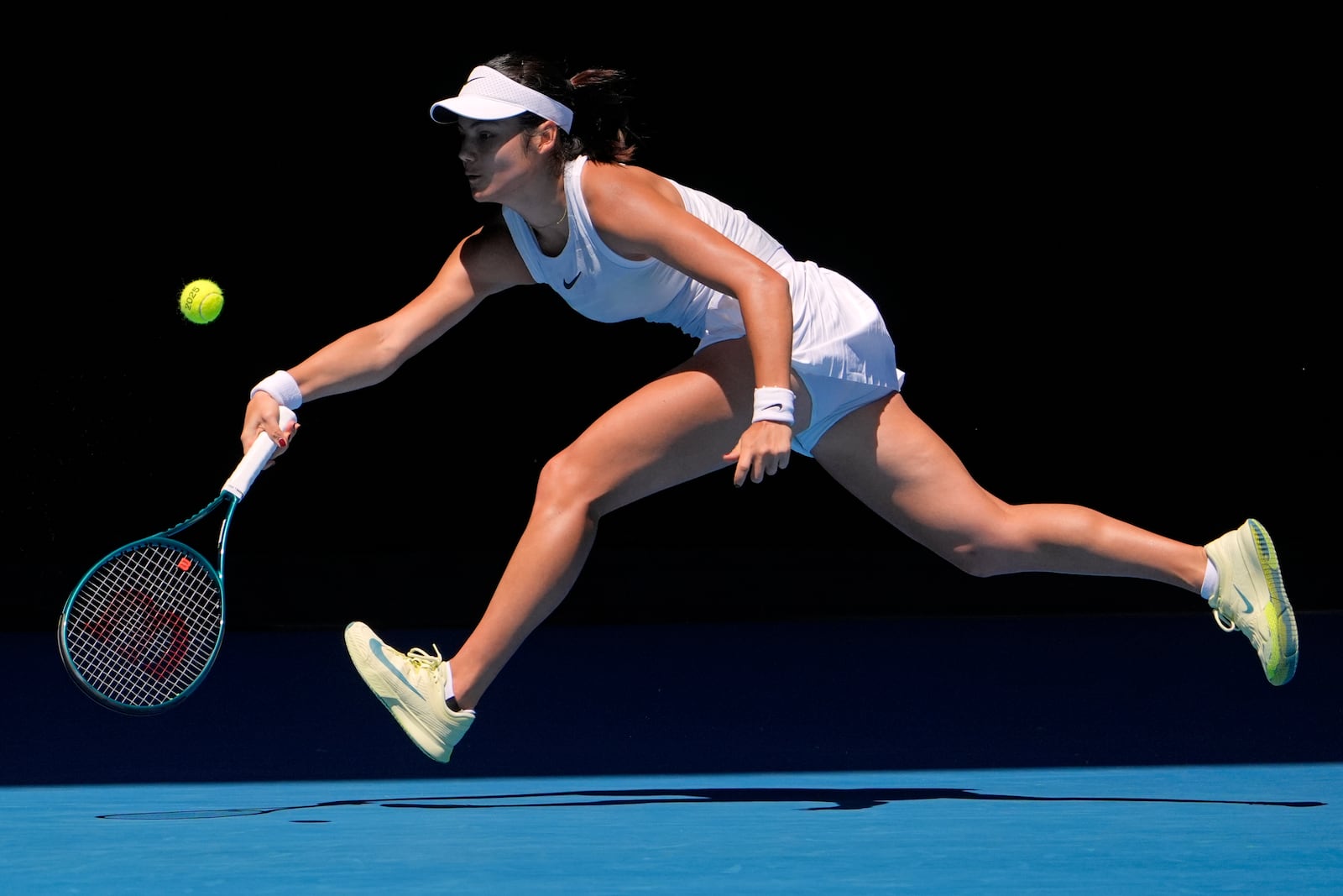 Emma Raducanu of Britain plays a forehand return to Iga Swiatek of Poland during their third round match at the Australian Open tennis championship in Melbourne, Australia, Saturday, Jan. 18, 2025. (AP Photo/Asanka Brendon Ratnayake)