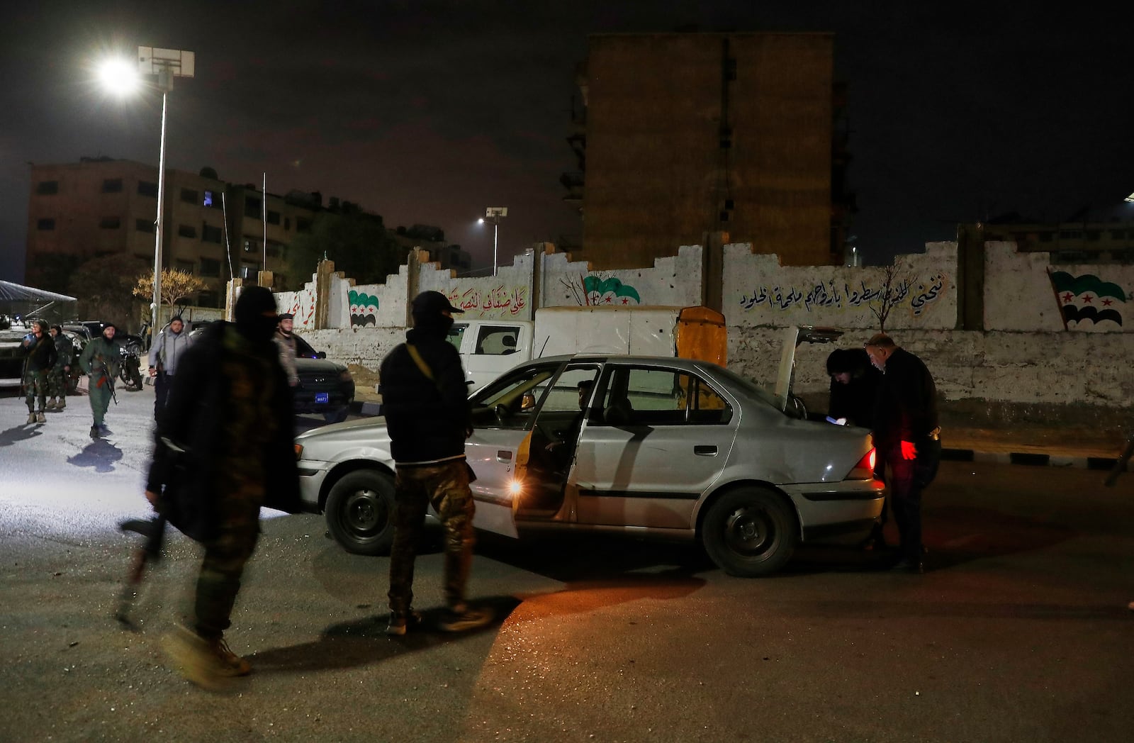 Government security forces check a car after they deployed in the town of Harasta, on the outskirts of Damascus, Syria, Thursday, March 6, 2025. (AP Photo/Omar Sanadiki)