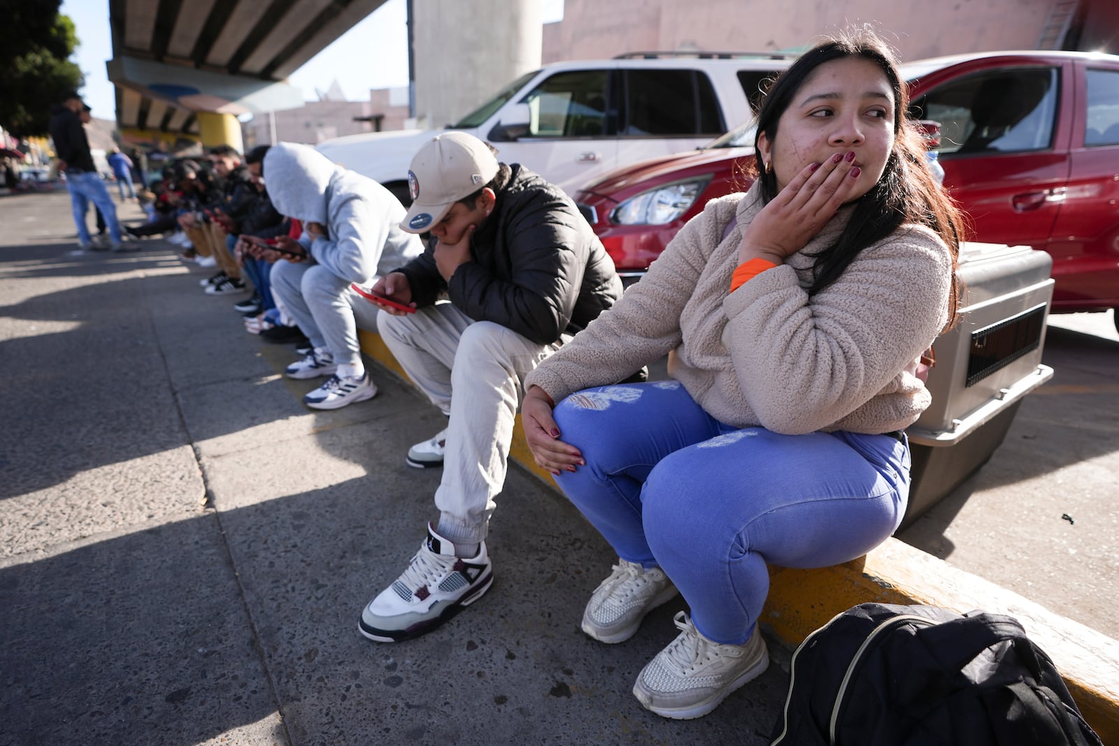 Melanie Mendoza of Venezuela, gets emotional as she sees that her 1pm appointment was canceled on the U.S. Customs and Border Protection (CBP) One app, as she and her family wait at the border crossing in Tijuana, Mexico on Monday, Jan. 20. 2025. (AP Photo/Gregory Bull)