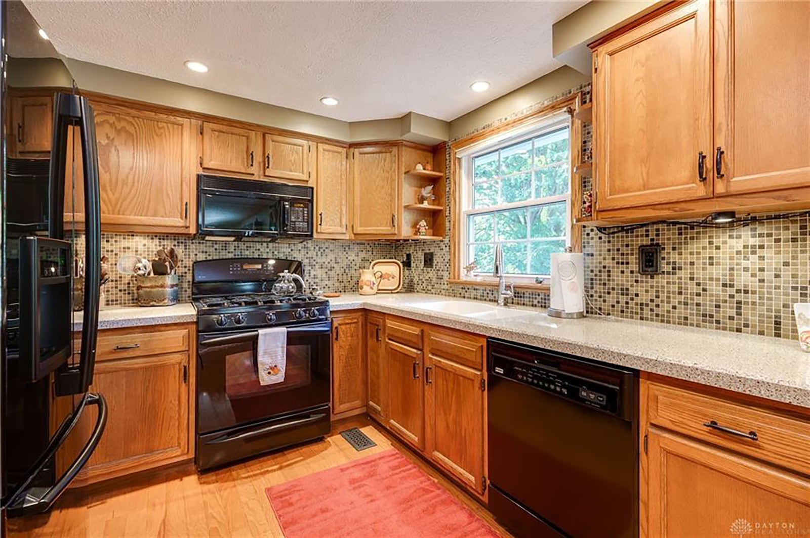 The kitchen is updated and has hardwood flooring, all appliances, granite countertops and a breakfast bar.