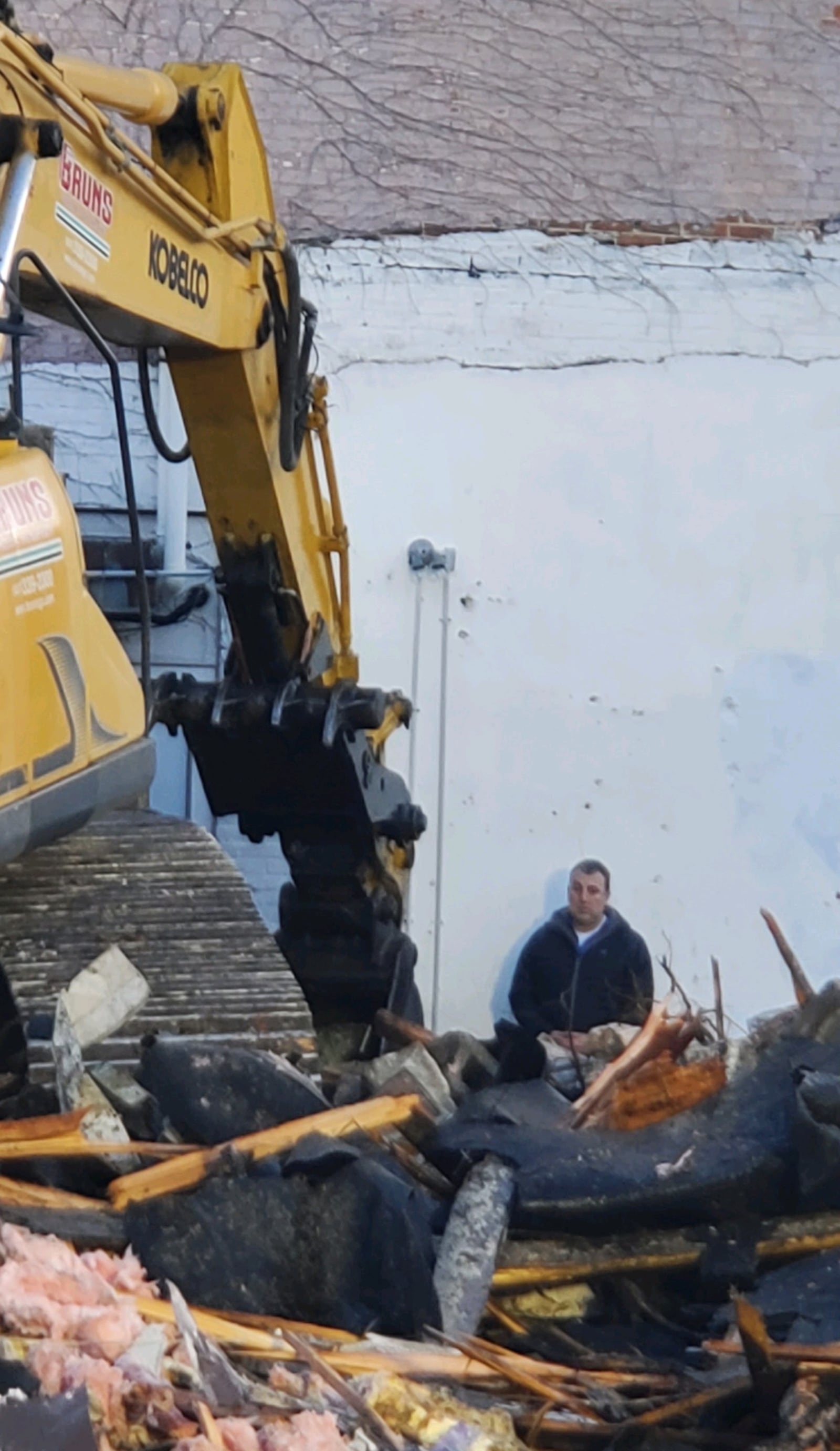 Troy Historic Preservation Alliance member Ben Sutherly stands in front of heavy equipment demolishing part of the Troy Tavern building on Wednesday morning, March 29, 2023. CONTRIBUTED PHOTO