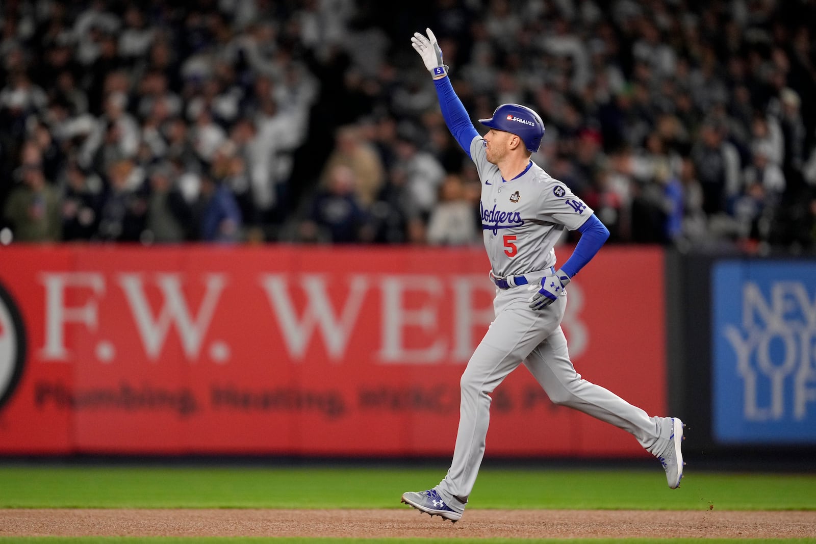 Los Angeles Dodgers' Freddie Freeman celebrates a two-run home run against the New York Yankees during the first inning in Game 3 of the baseball World Series, Monday, Oct. 28, 2024, in New York. (AP Photo/Ashley Landis)