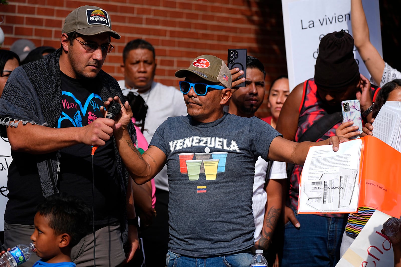 FILE - Moises Didenot speaks during a rally by the East Colfax Community Collective to address chronic problems in the apartment buildings occupied by people displaced from their home countries in central and South America, Sept. 3, 2024, in Aurora, Colo. (AP Photo/David Zalubowski, File)