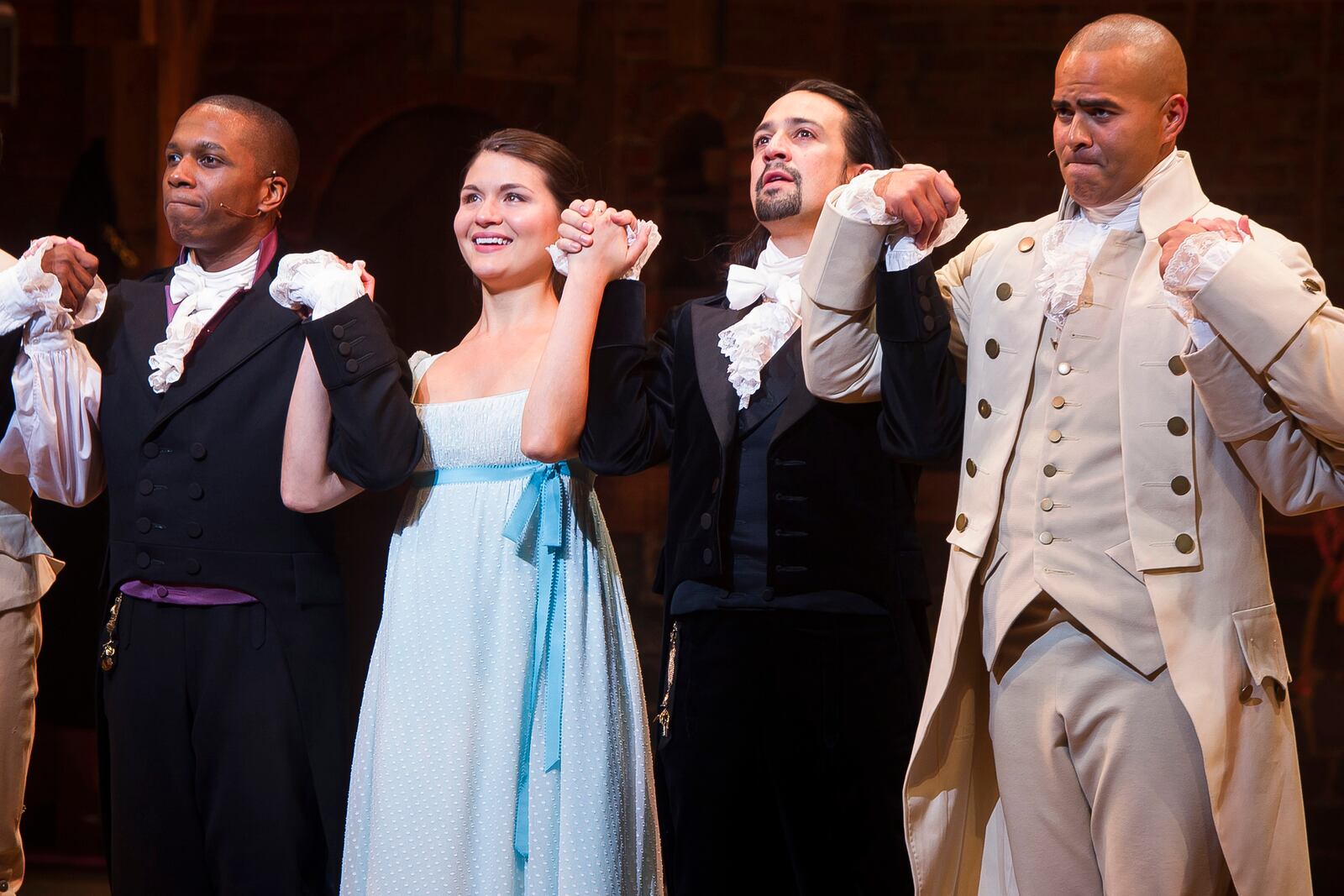 In this Thursday, Aug. 6, 2015, file photo, Leslie Odom Jr., from left, Phillipa Soo, Lin-Manuel Miranda and Christopher Jackson appear at the curtain call following the opening night performance of "Hamilton" at the Richard Rodgers Theatre in New York. Fans of Broadway gave producers reasons to smile this Christmas, with 18 of the current 37 shows breaking the $1 million mark for the week, led by Hamilton, the new Andrew Lloyd Webber musical School of Rock _ The Musical and Disneys Aladdin and The Lion King. (Photo by Charles Sykes/Invision/AP, File)