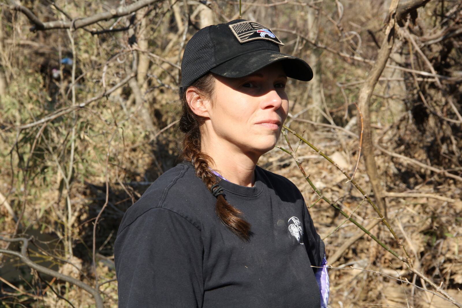 Jill Holtz gazes out at the hurricane-ravaged landscape at a cornfield in Swannanoa, N.C., on Thursday, Feb. 6, 2025. (AP Photo/Makiya Seminera)