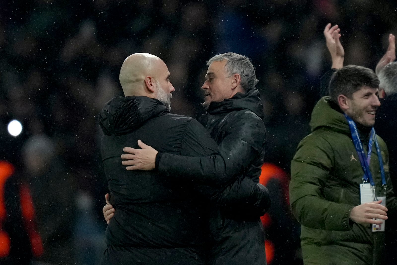 Manchester City's head coach Pep Guardiola, left, and PSG's head coach Luis Enrique embrace each other at the end of a Champions League opening phase soccer match between Paris Saint-Germain and Manchester City at the Parc des Princes in Paris, Wednesday, Jan. 22, 2025. (AP Photo/Thibault Camus)