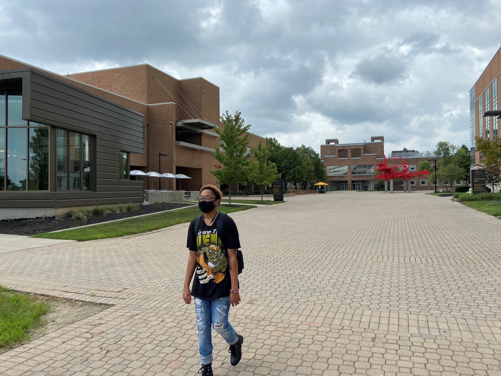 Wright State University Freshman Tyler Mikel leaves campus after class on Aug. 27. The university requires all students and employees to wear masks to help slow the spread of the COVID-19 on campus. /ISMAIL TURAY JR.