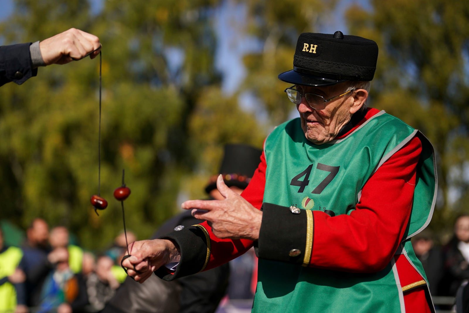 Chelsea pensioner John Riley takes part in the annual World Conker Championships at the Shuckburgh Arms in Southwick, Peterborough, England, Sunday Oct. 13, 2024. (Jacob King/PA via AP)