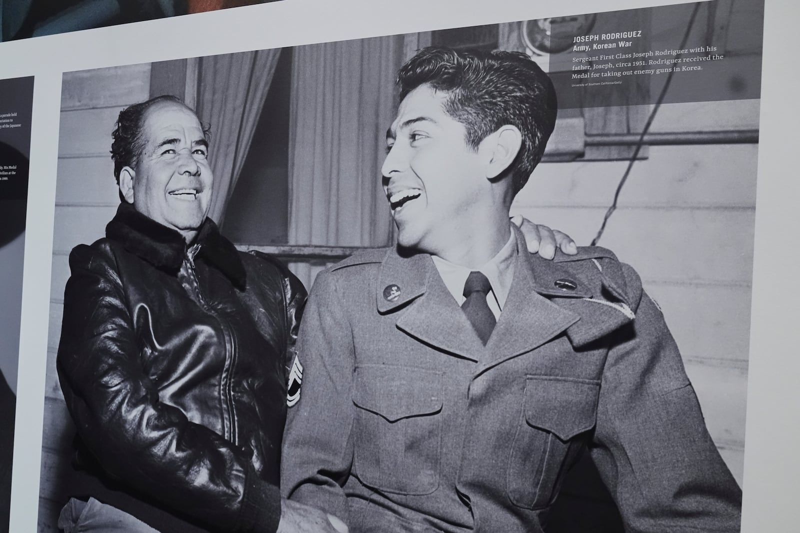 An image of Korea war Medal of Honor recipient Sgt. First Class Joseph Rodriguez, right, interacting with his father, Joseph, left, is on display at the National Medal of Honor Museum in Arlington, Texas, Thursday, March 13, 2025. (AP Photo/Tony Gutierrez)