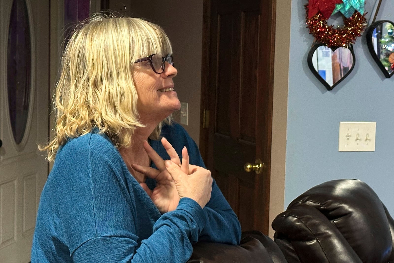 Stacey Collins Gardiner reacts to seeing her son, Travis Timmerman, on the news Thursday, Dec. 12, 2024, in her home in Urbana, Mo. Timmerman, an American citizen, was found outside Damascus, Syria, and had been imprisoned for months after crossing from Lebanon into Syria on a Christian pilgrimage. (AP Photo/Nick Ingram)