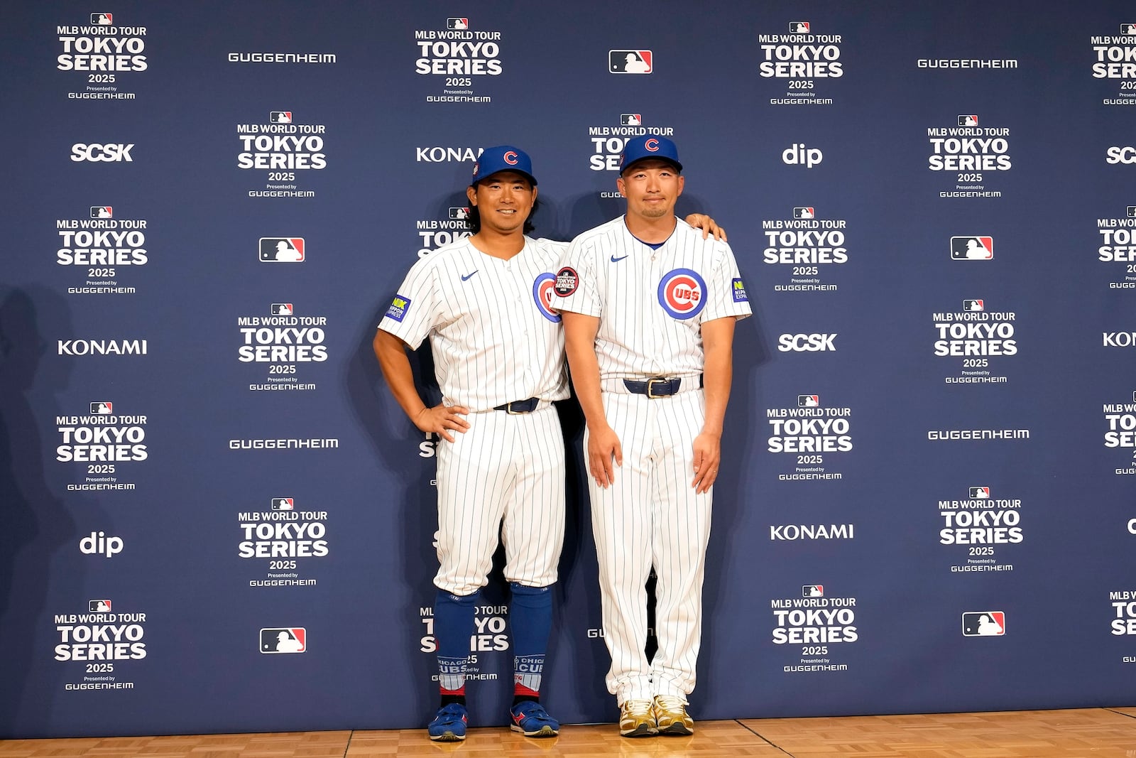 Seiya Suzuki, right, and Shota Imanaga, left, of the Chicago Cubs, pose for photographers after attending an official news conference Friday, March 14, 2025, in Tokyo, before the Cubs play their MLB opening baseball games against the Los Angeles Dodgers at Tokyo Dome next week. (AP Photo/Eugene Hoshiko)