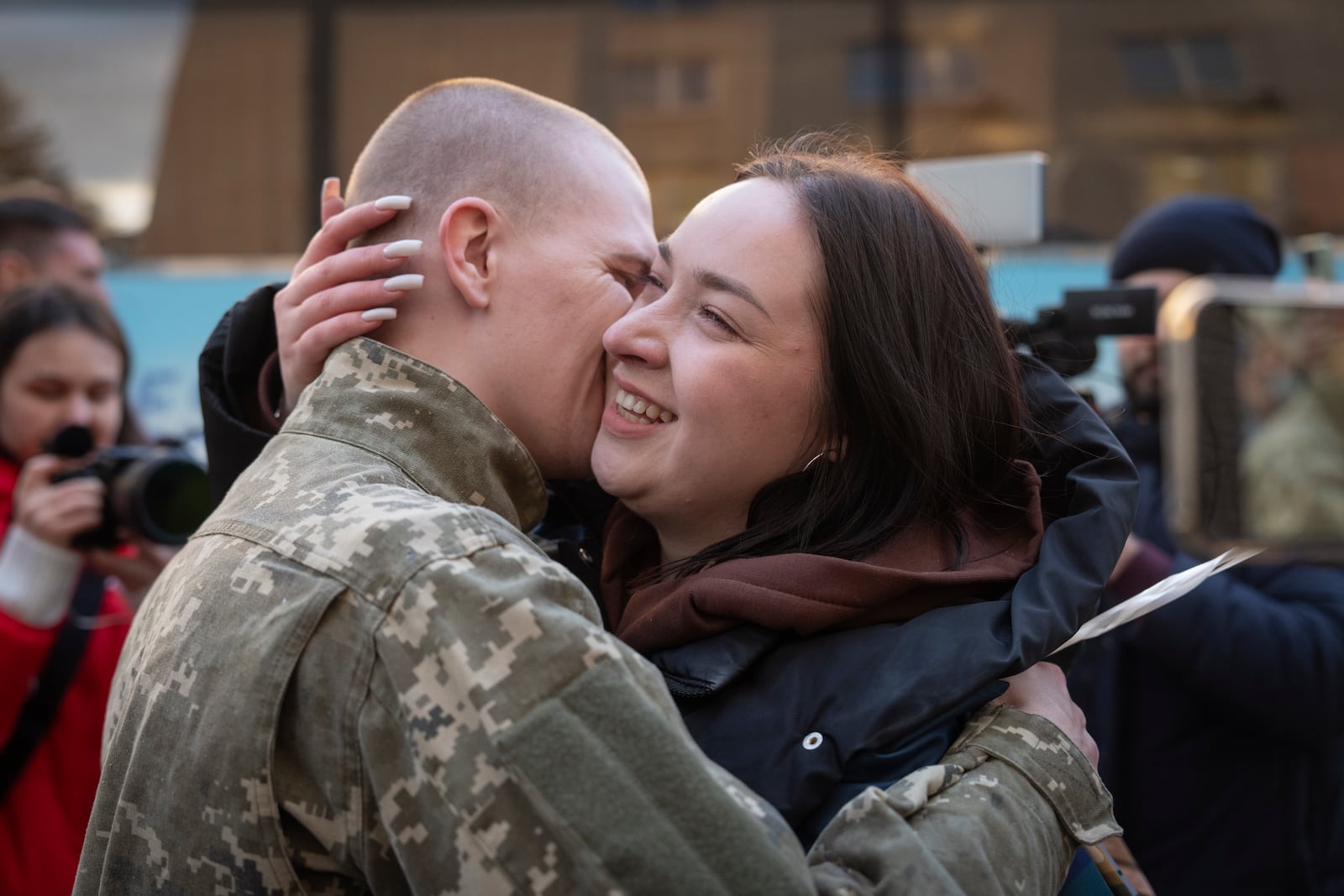 Ukrainian serviceman Andrii Orel, hugs his fiance Aliona after returning from captivity during a POWs exchange between Russia and Ukraine in Chernyhiv region, Ukraine, Wednesday, March 19, 2025. (AP Photo/Efrem Lukatsky)