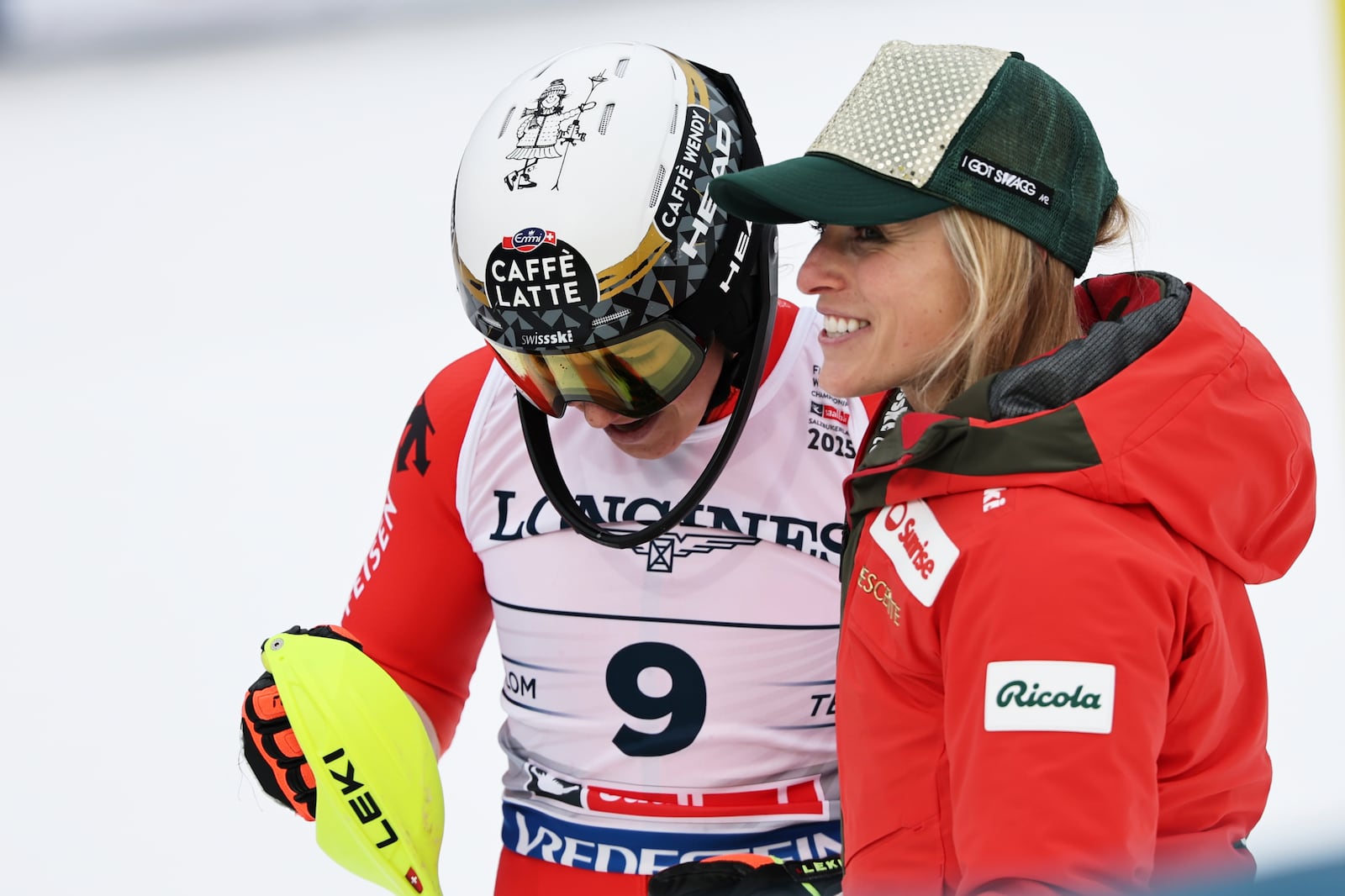 Switzerland's Wendy Holdener, left, celebrates with Switzerland's Lara Gut Behrami at the finish area of a slalom run of a women's team combined event, at the Alpine Ski World Championships, in Saalbach-Hinterglemm, Austria, Tuesday, Feb. 11, 2025. (AP Photo/Marco Trovati)