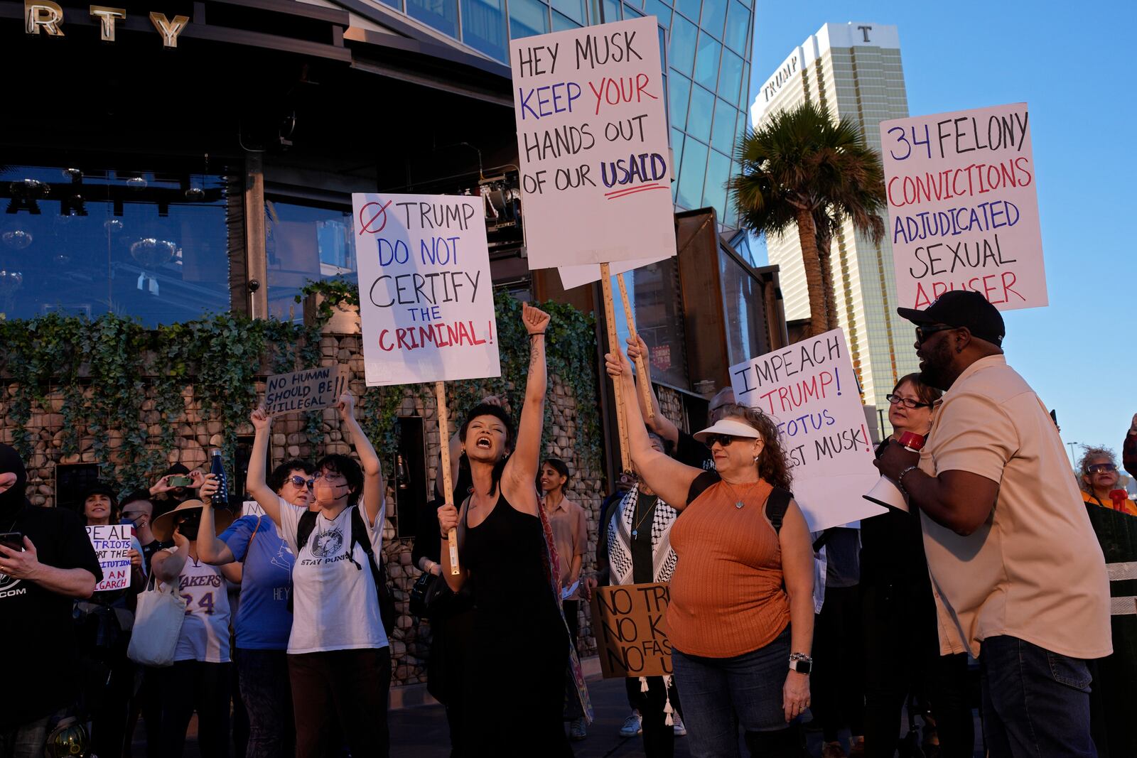 Demonstrators chant to protest against the Trump administration near the Trump International Hotel along the Las Vegas Strip, Wednesday, Feb. 5, 2025, in Las Vegas. (AP Photo/John Locher)