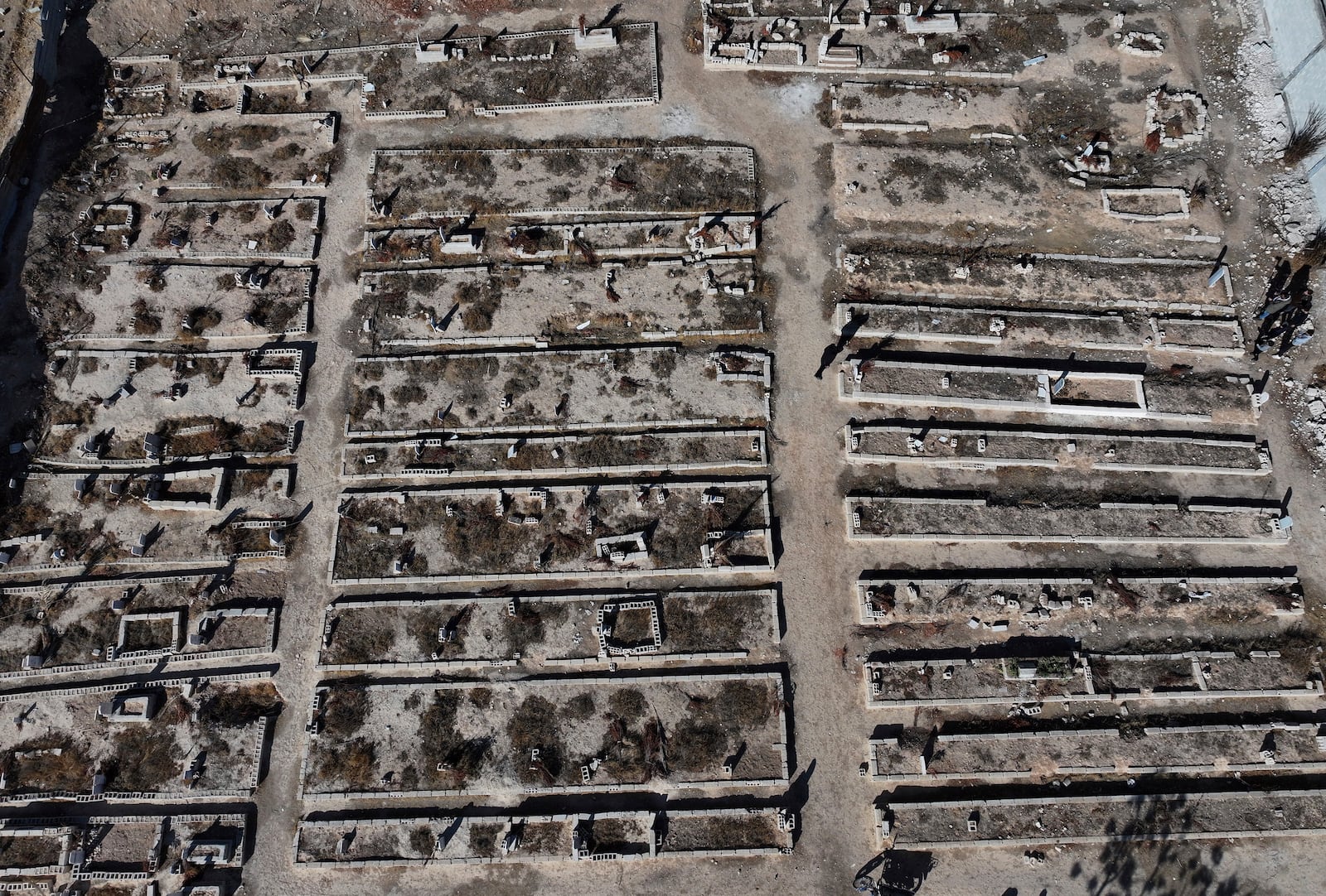 An arial view shows a mass grave where are buried those who were killed by the sarin struck during a 2013 chemical weapons attack that was blamed on then President Bashar Assad's forces, in Zamalka neighbourhood, on the outskirts of Damascus, Syria, Wednesday, Dec. 25, 2024. (AP Photo/Hussein Malla)