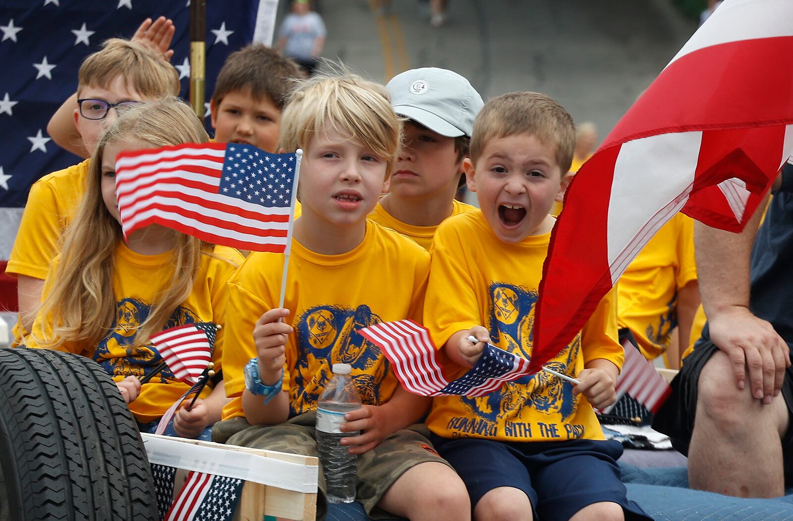 Hundreds of people put on their best red, white and blue attire and came out to watch the Springfield Memorial Day Monday, May 27, 2024. Men, women and children waved American flags and cheered as the parade marched by with veterans, flags, firetrucks and bands paying tribute to the nations fallen service men and women. BILL LACKEY/STAFF